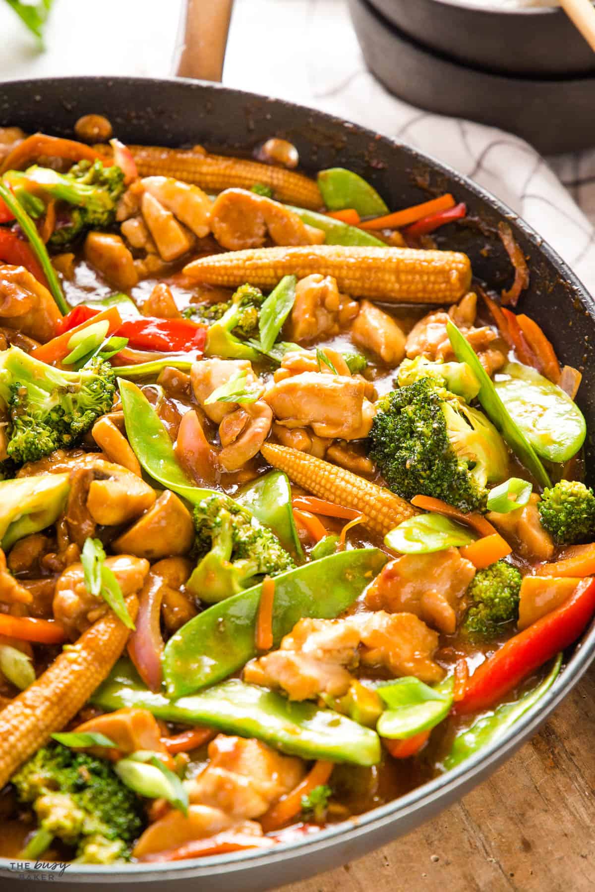 chicken stir fry recipe in skillet with veggies