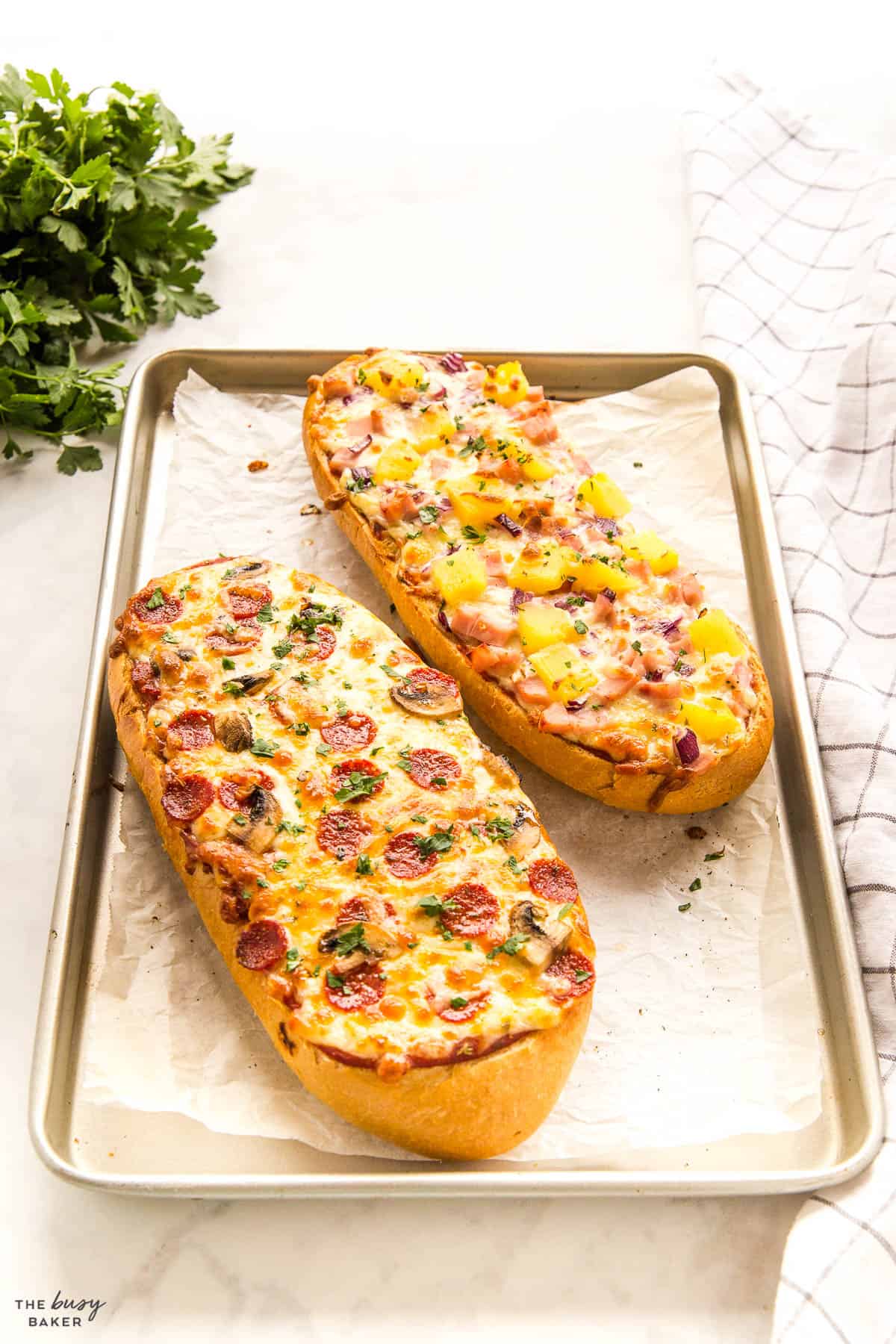 french bread pizza on sheet pan with pepperoni, mushrooms, ham and pineapple