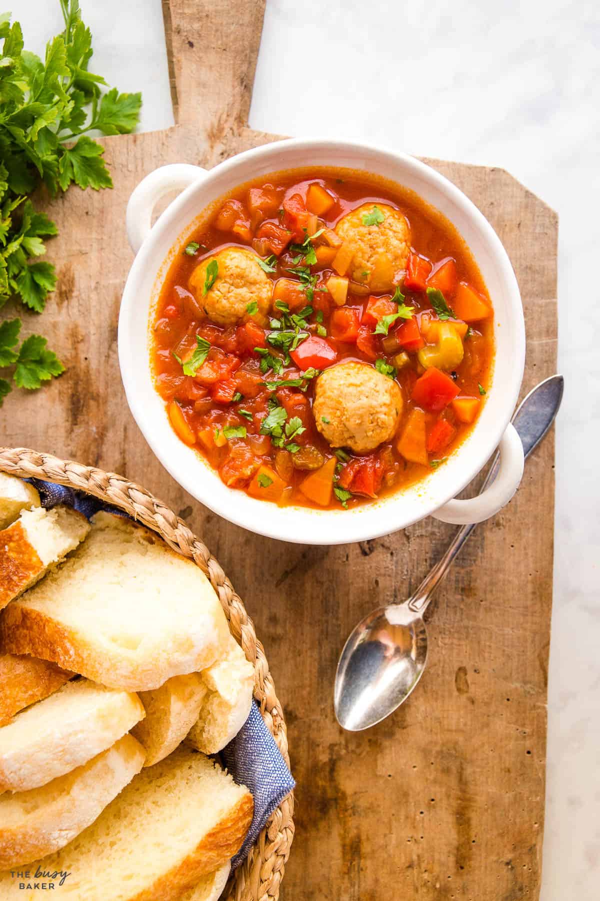 overhead image: meatball soup with a basket of bread