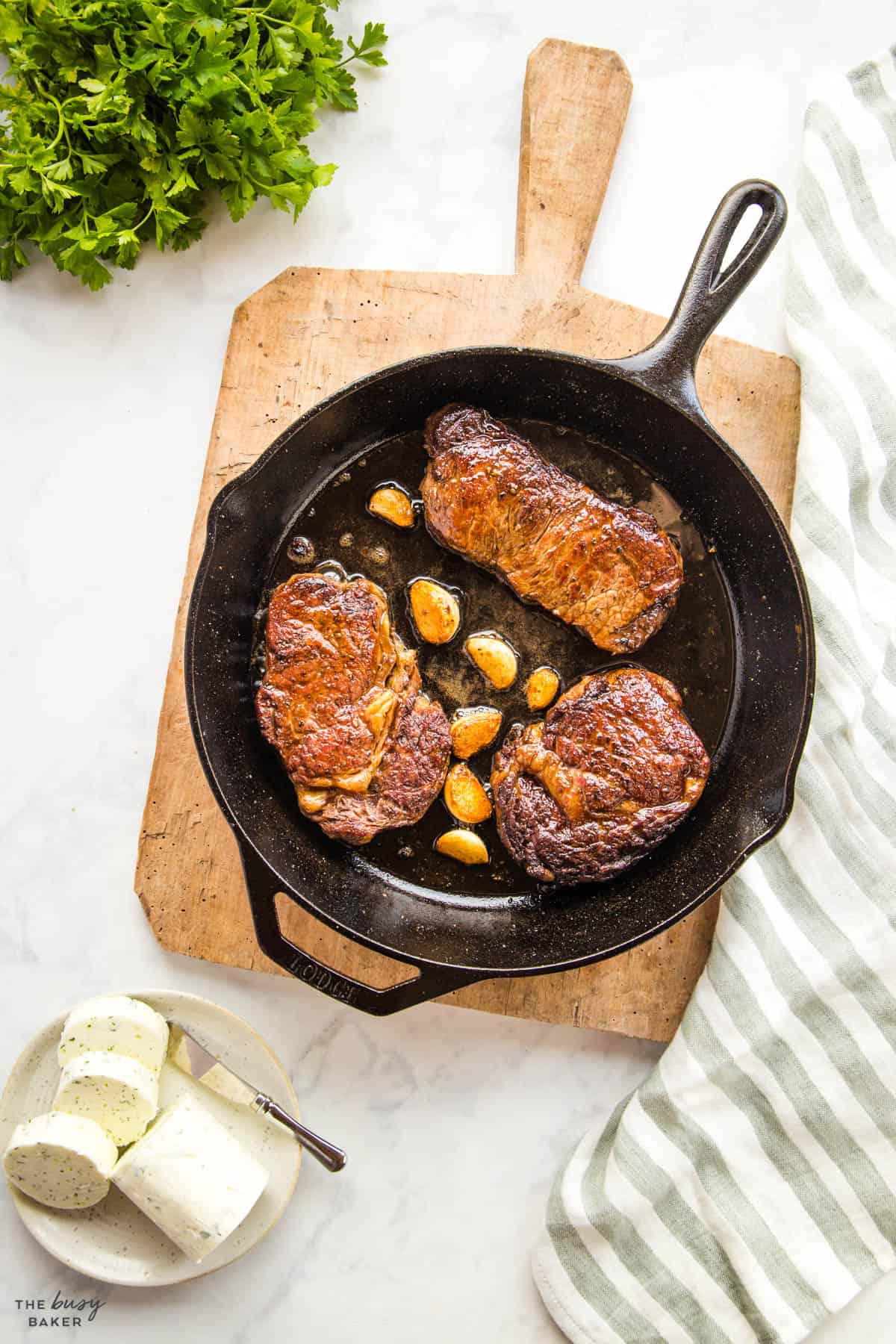 overhead image: cast iron skillet steak with garlic