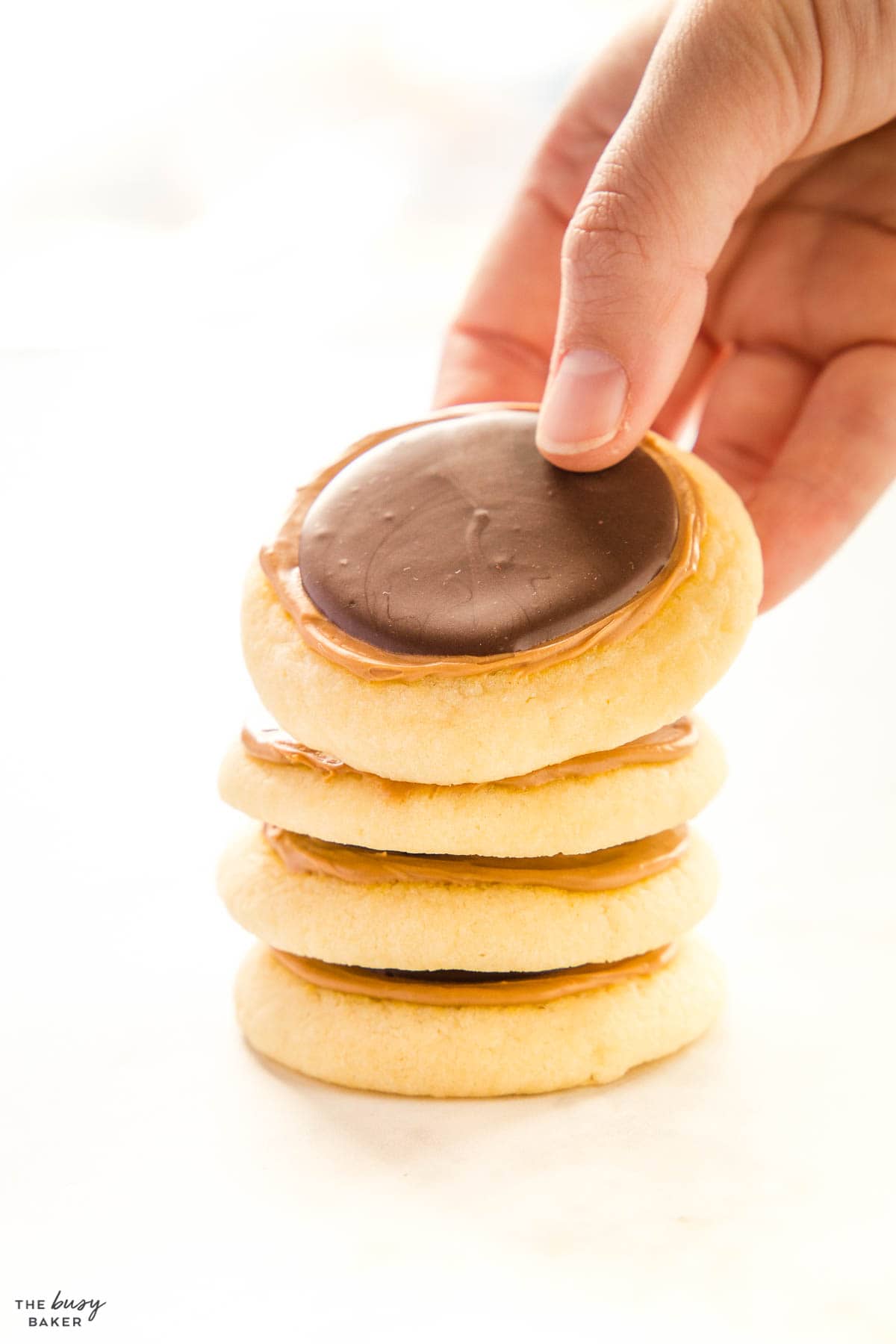 hand reaching for a stack of twix cookies