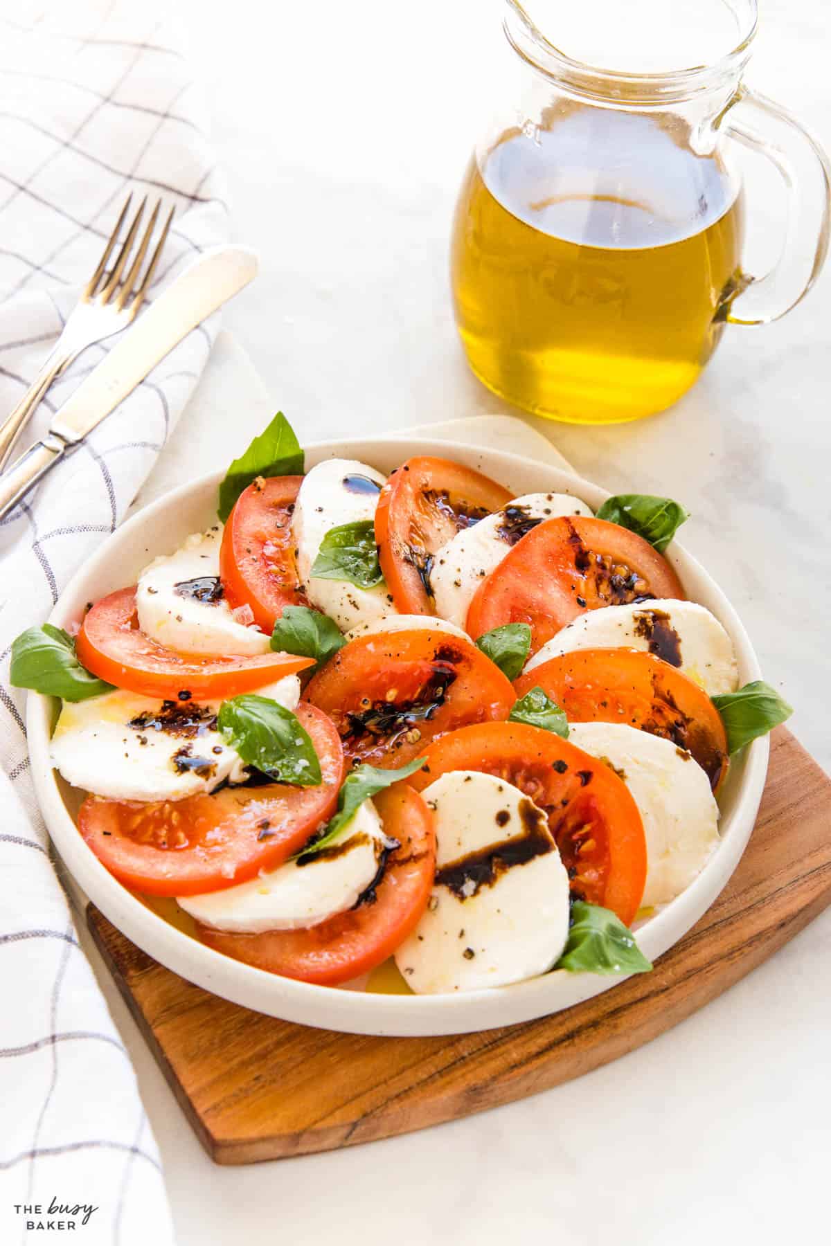 caprese salad on a plate with olive oil and balsamic vinegar