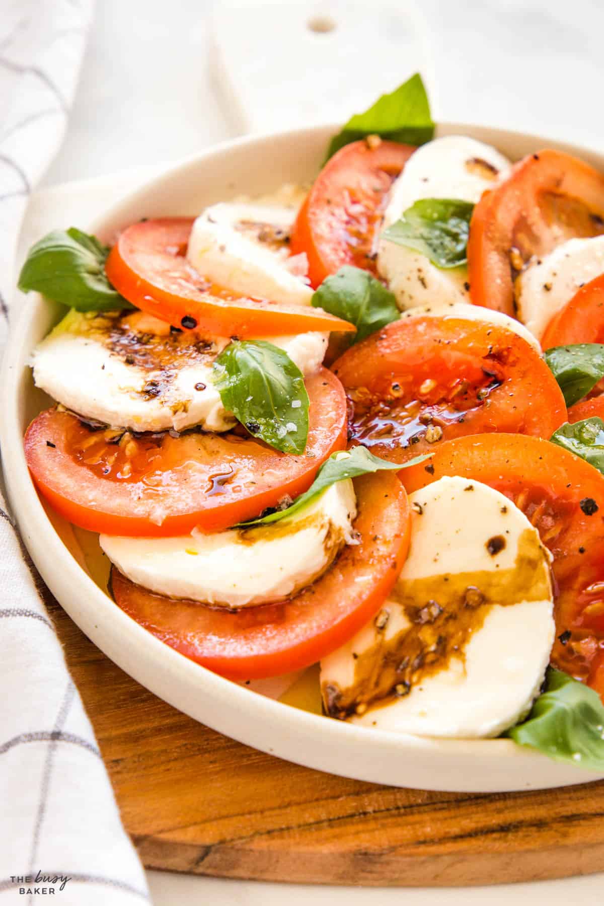 caprese salad recipe with tomatoes, mozzarella, basil, olive oil, balsamic and pepper