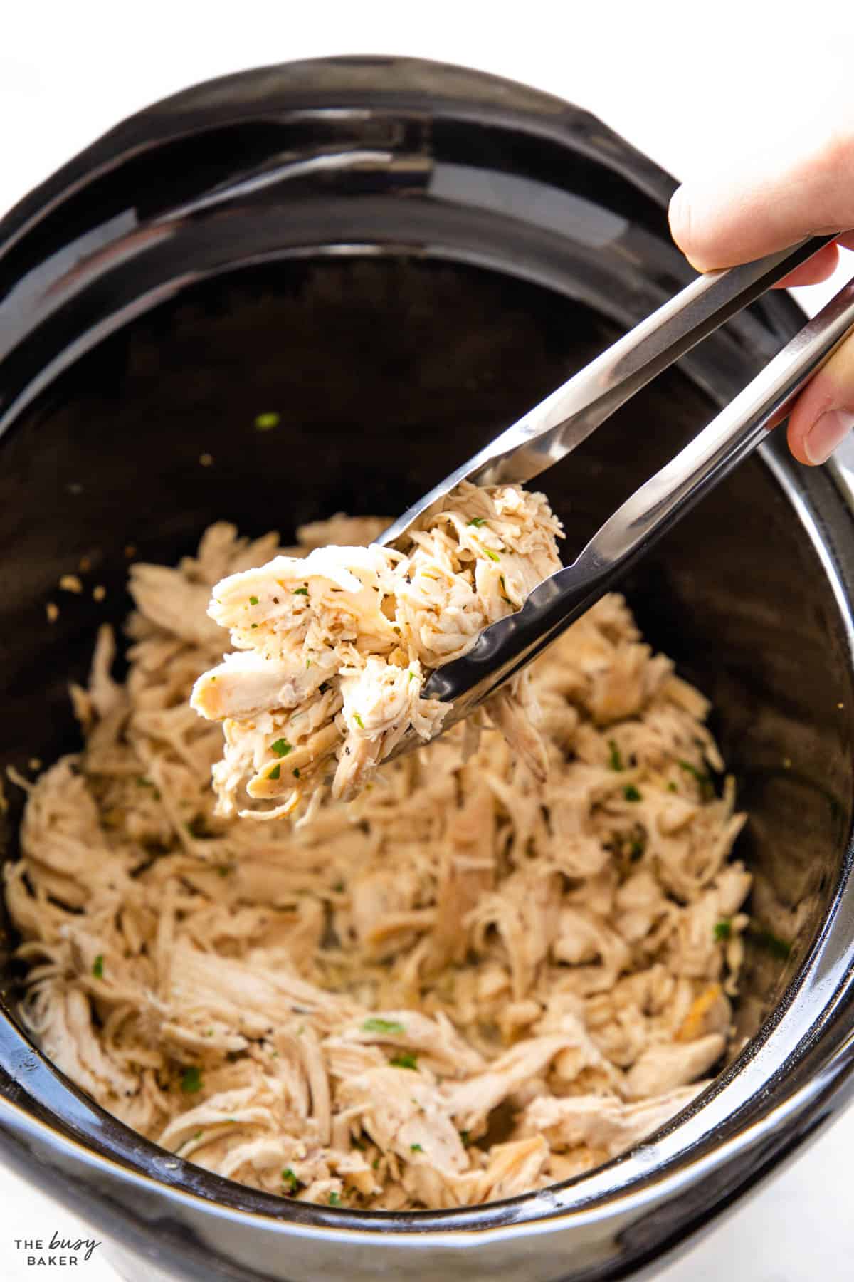 chicken in the crockpot with tongs