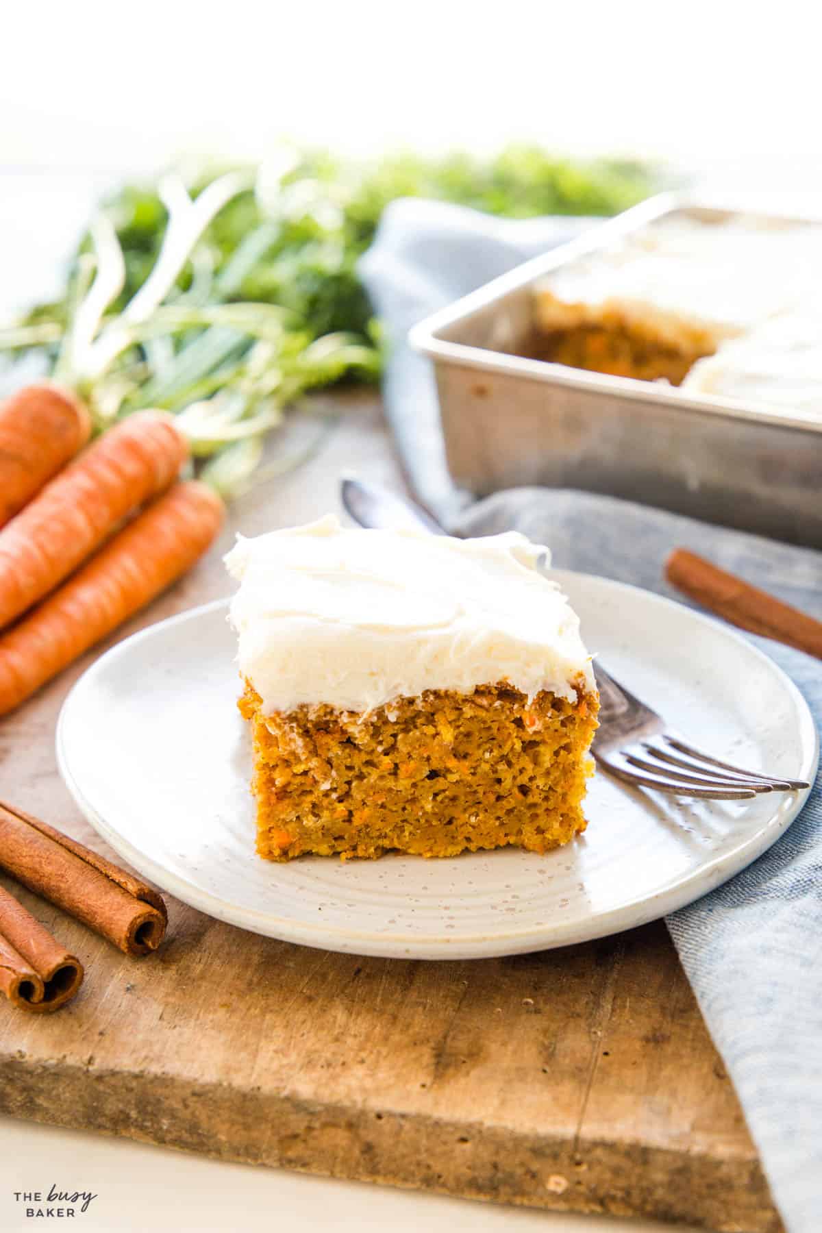 slice of carrot cake on a plate with a fork