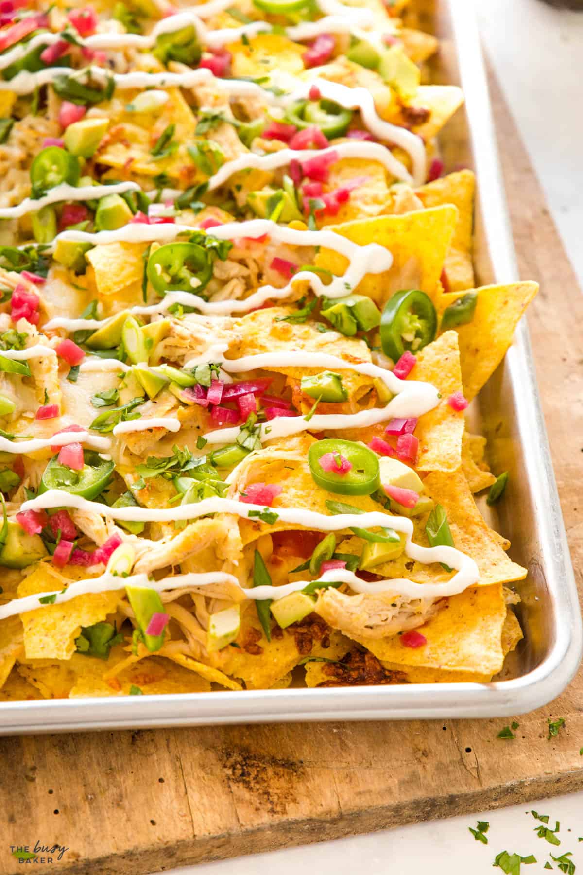 close up of sheet pan with chicken loaded nachos