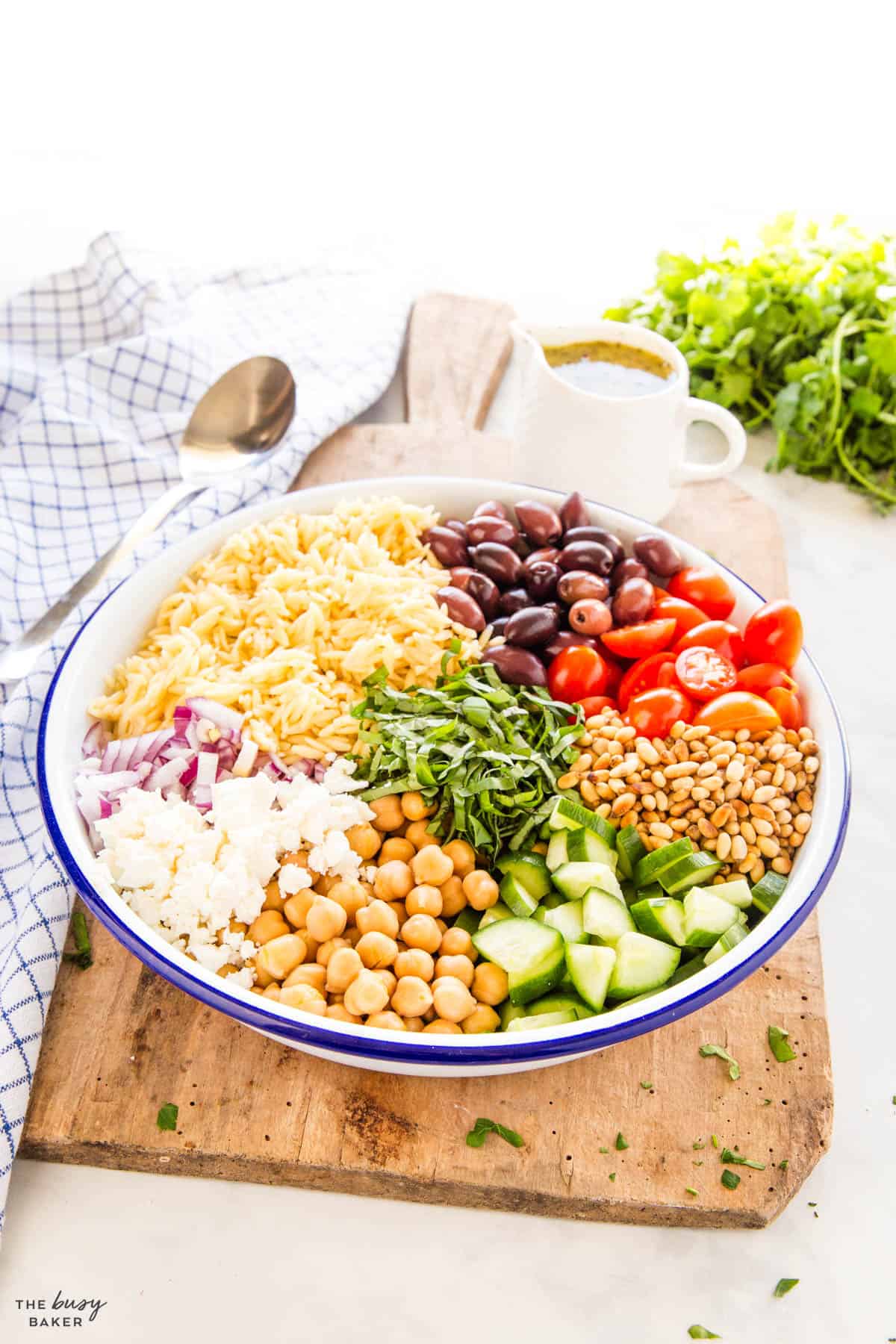 Greek salad with chickpeas, orzo and pine nuts