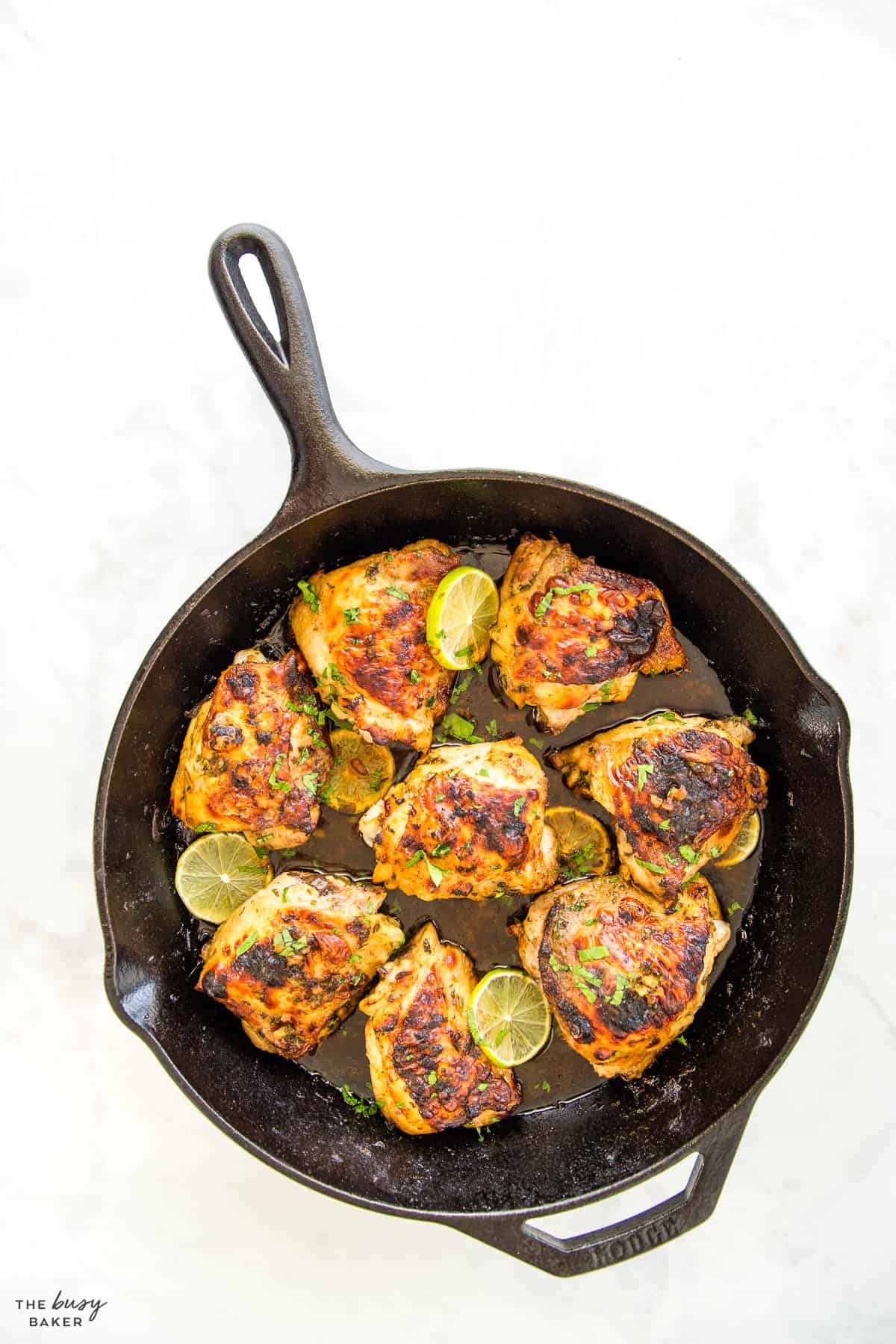 meat with fresh herbs and citrus in a cast iron skillet