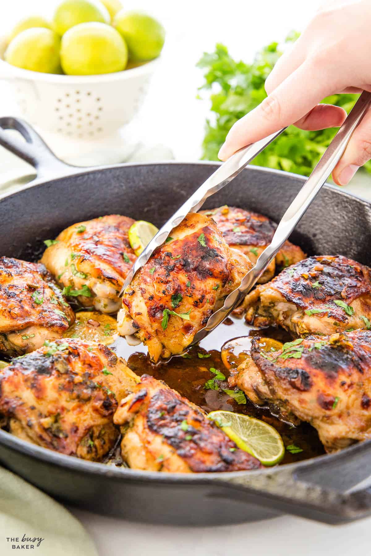 chicken thighs with cilantro and lime in a cast iron skillet