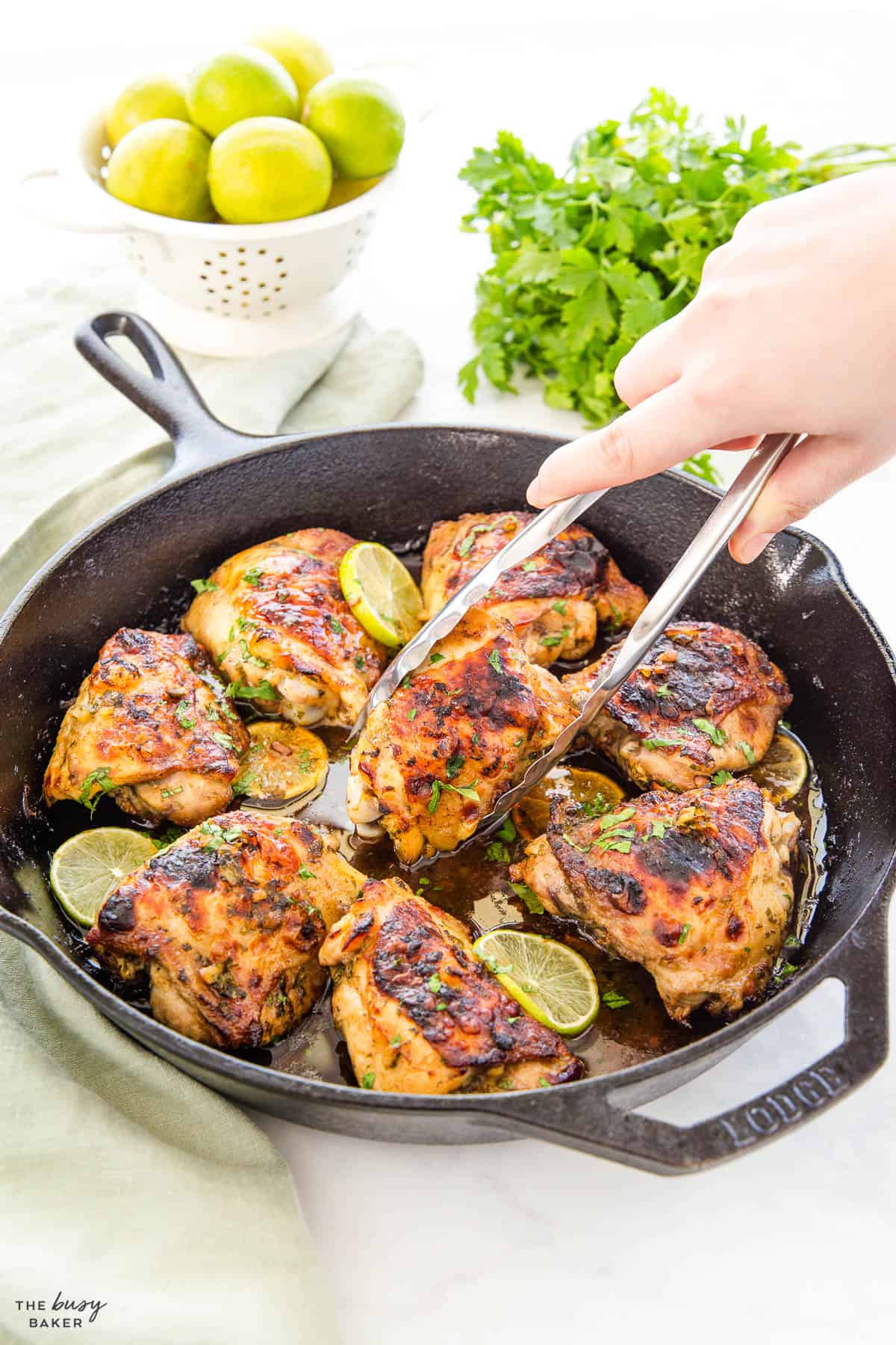 chicken thighs with cilantro and lime in a cast iron skillet