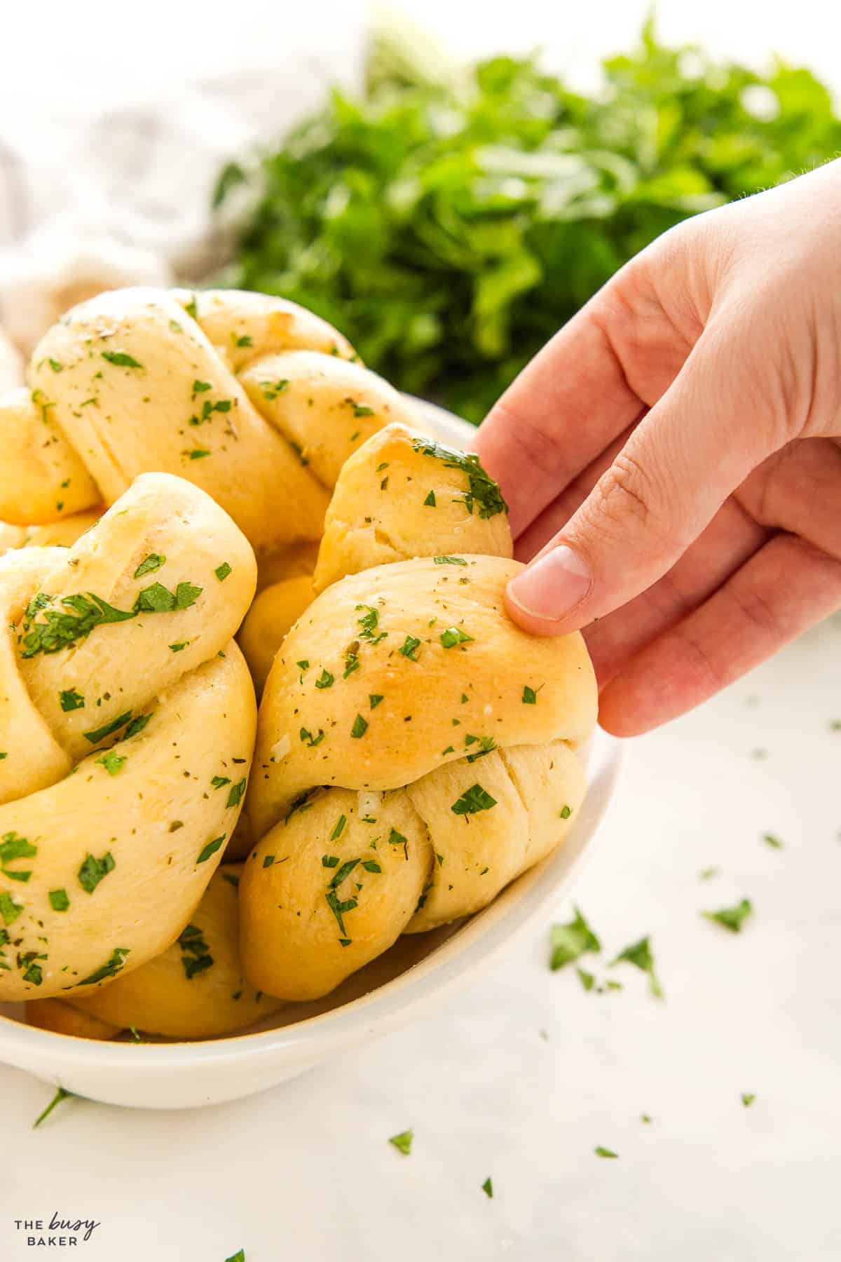 hand reaching for a garlic knot