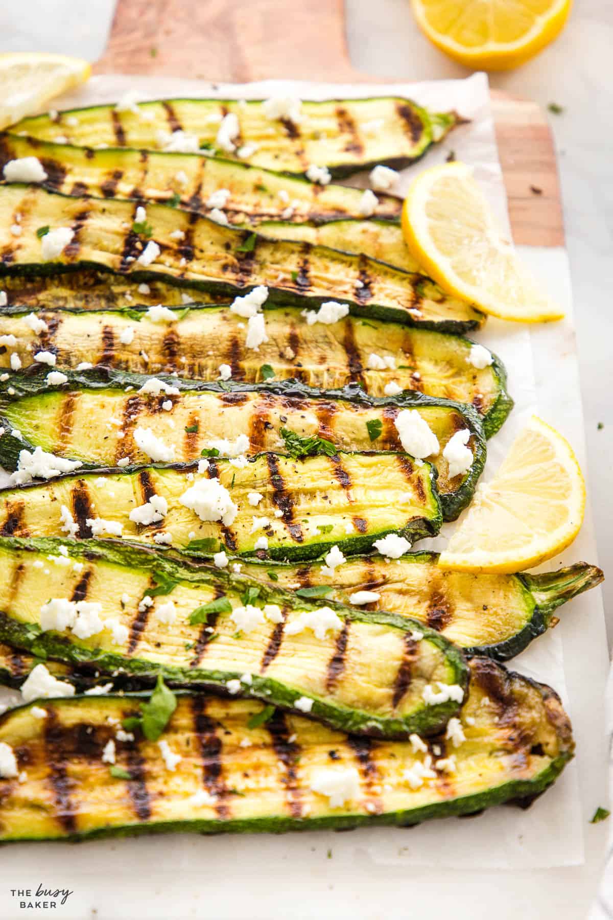 veggies with grill marks and feta cheese and lemon slices