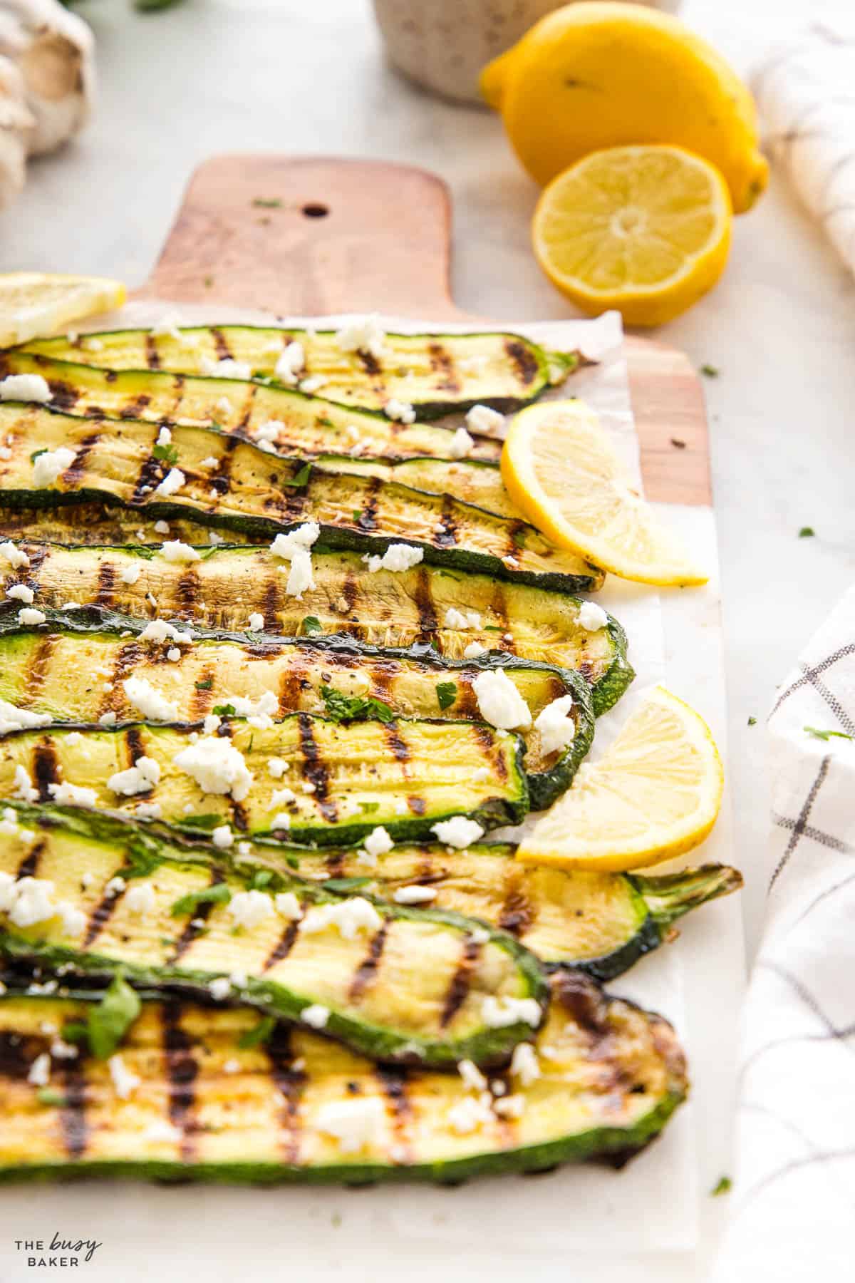 grilled zucchini with lemon slices and feta cheese