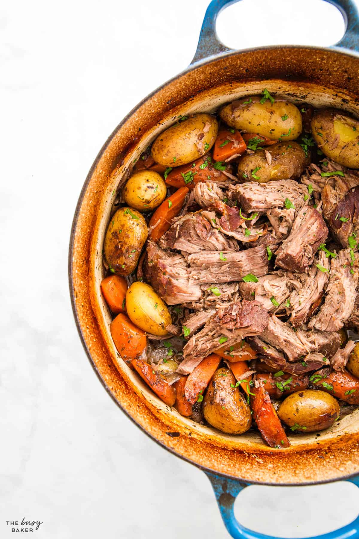 pot roast recipe in a blue cast iron dutch oven pot