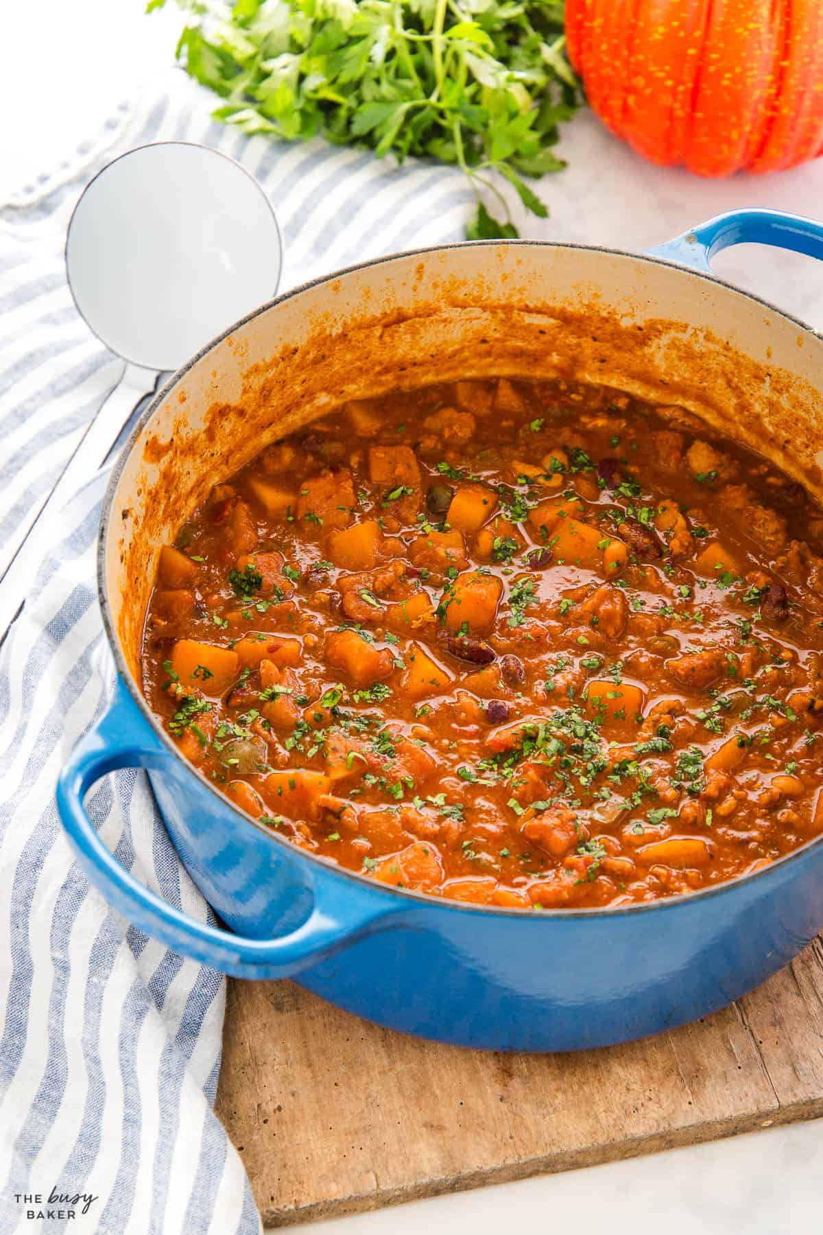 blue cast iron pot with stew made with veggies and beans