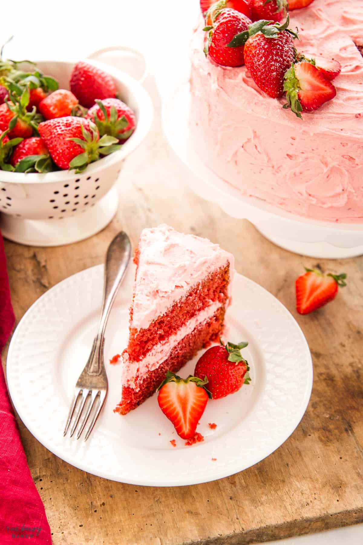 slice of homemade strawberry cake with strawberry buttercream frosting 