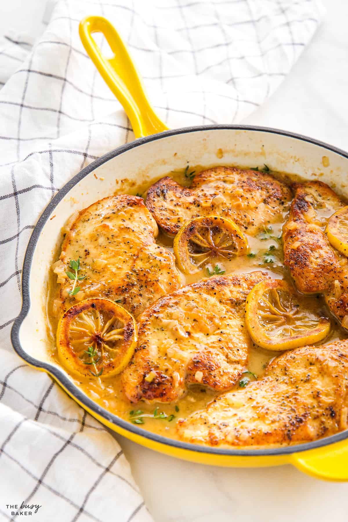 lemon pepper chicken in yellow skillet