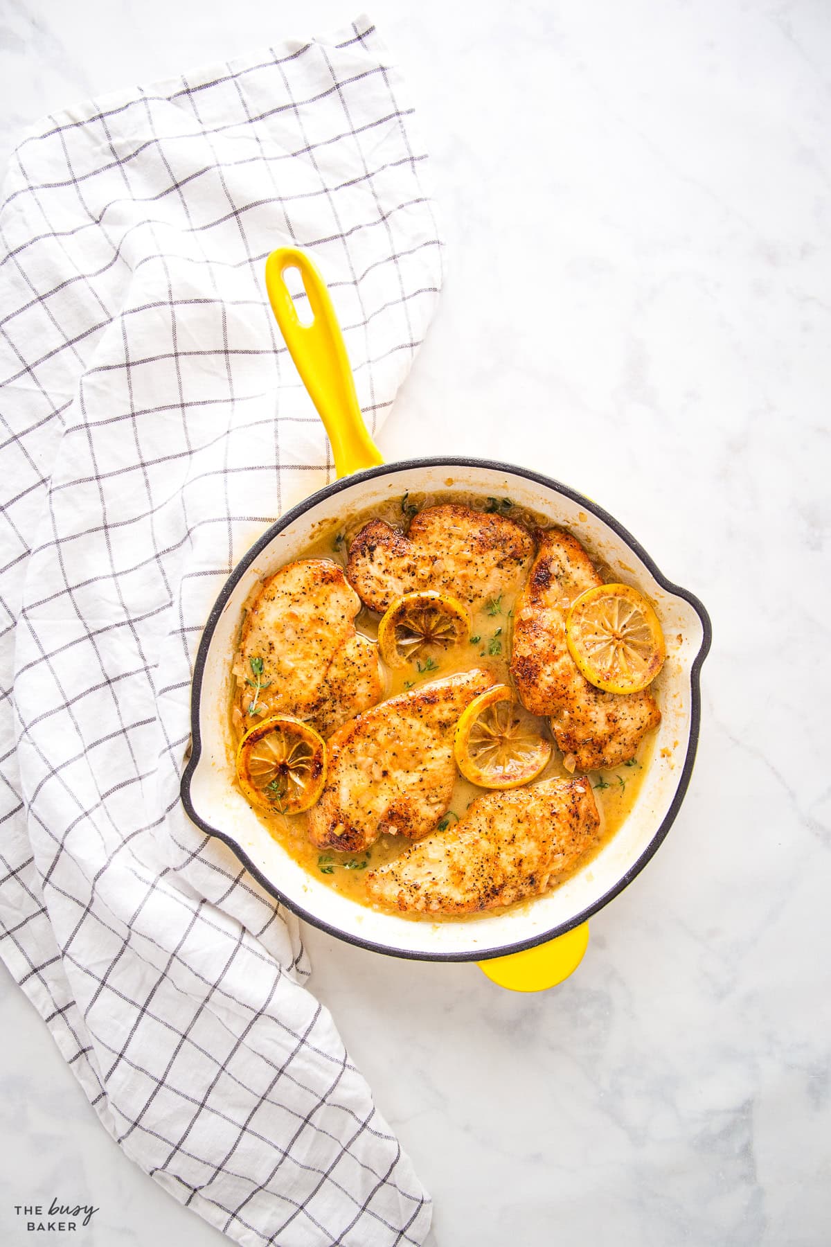 lemon chicken in a yellow skillet