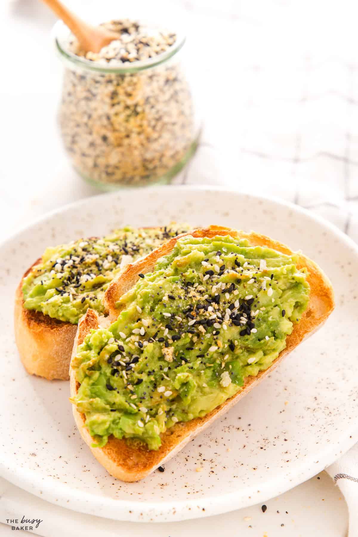 avocado toast on a white speckled plate