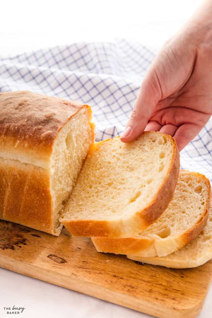 hand holding a slice of bread