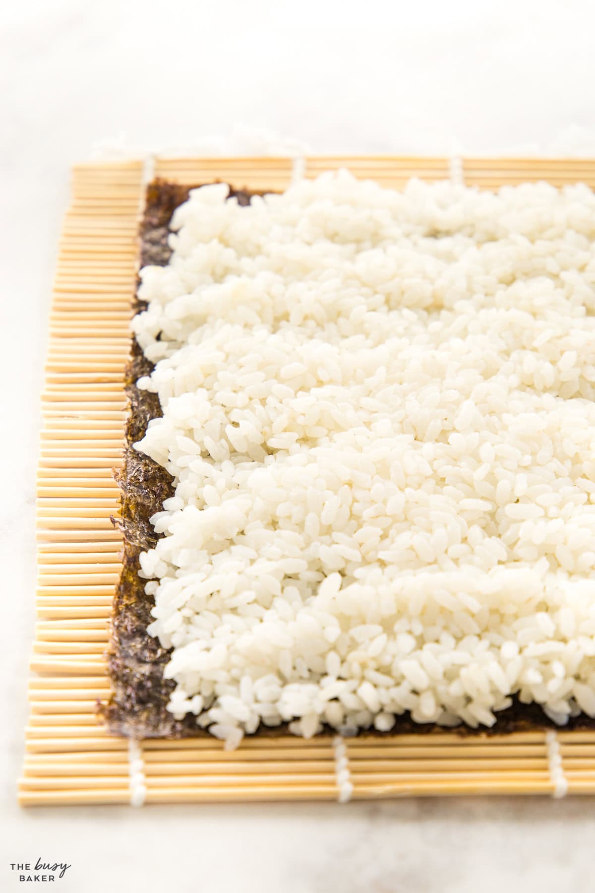 sushi rice on a piece of seaweed