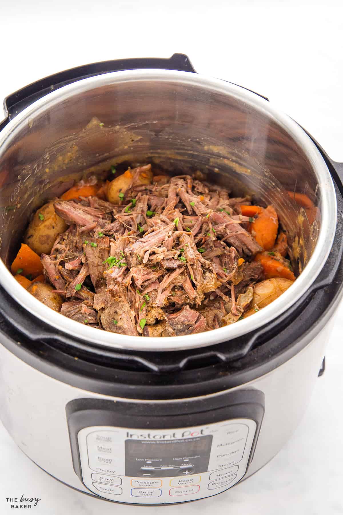 shredded beef in the Instant Pot with carrots and potatoes