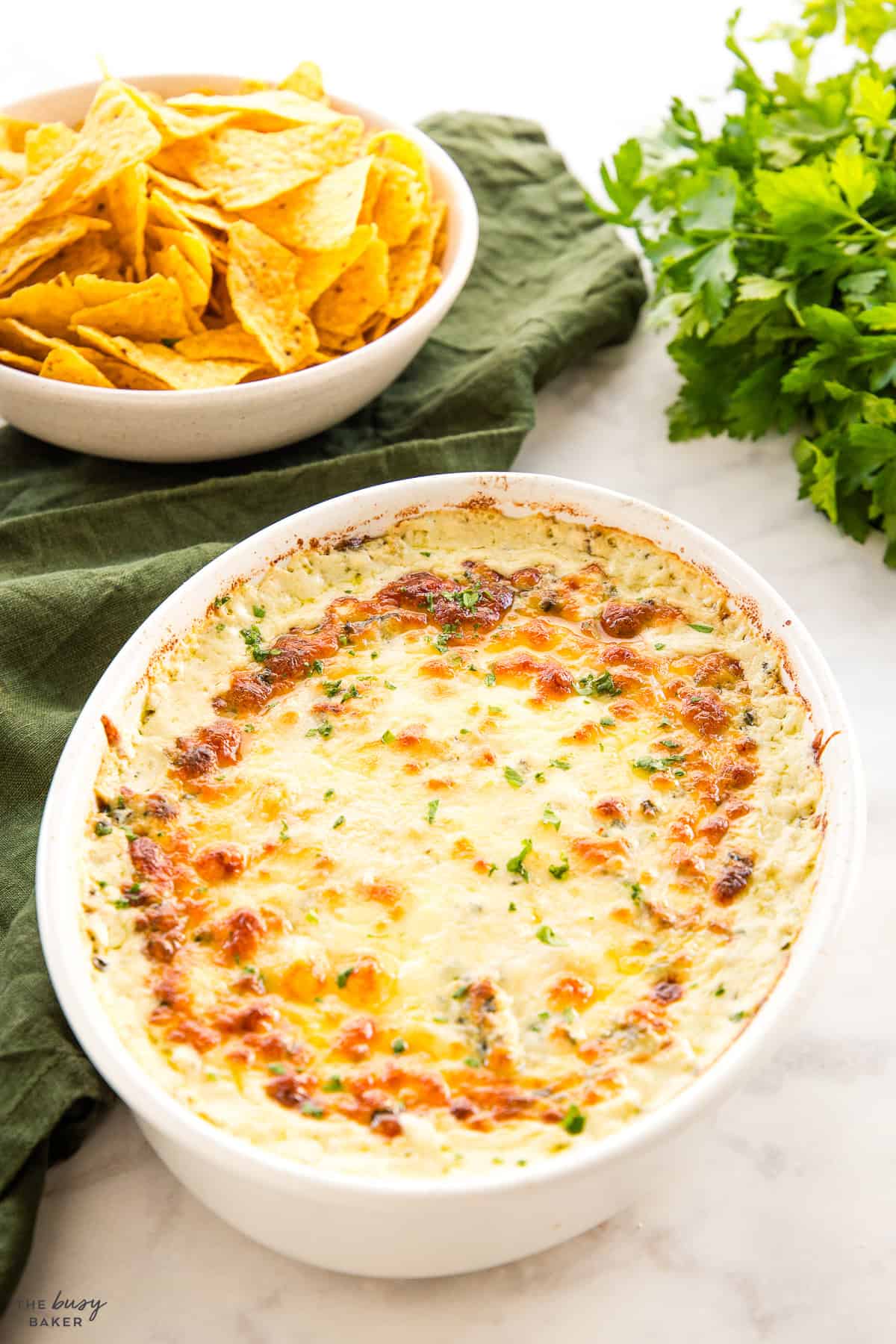 spinach artichoke dip in a white baking dish