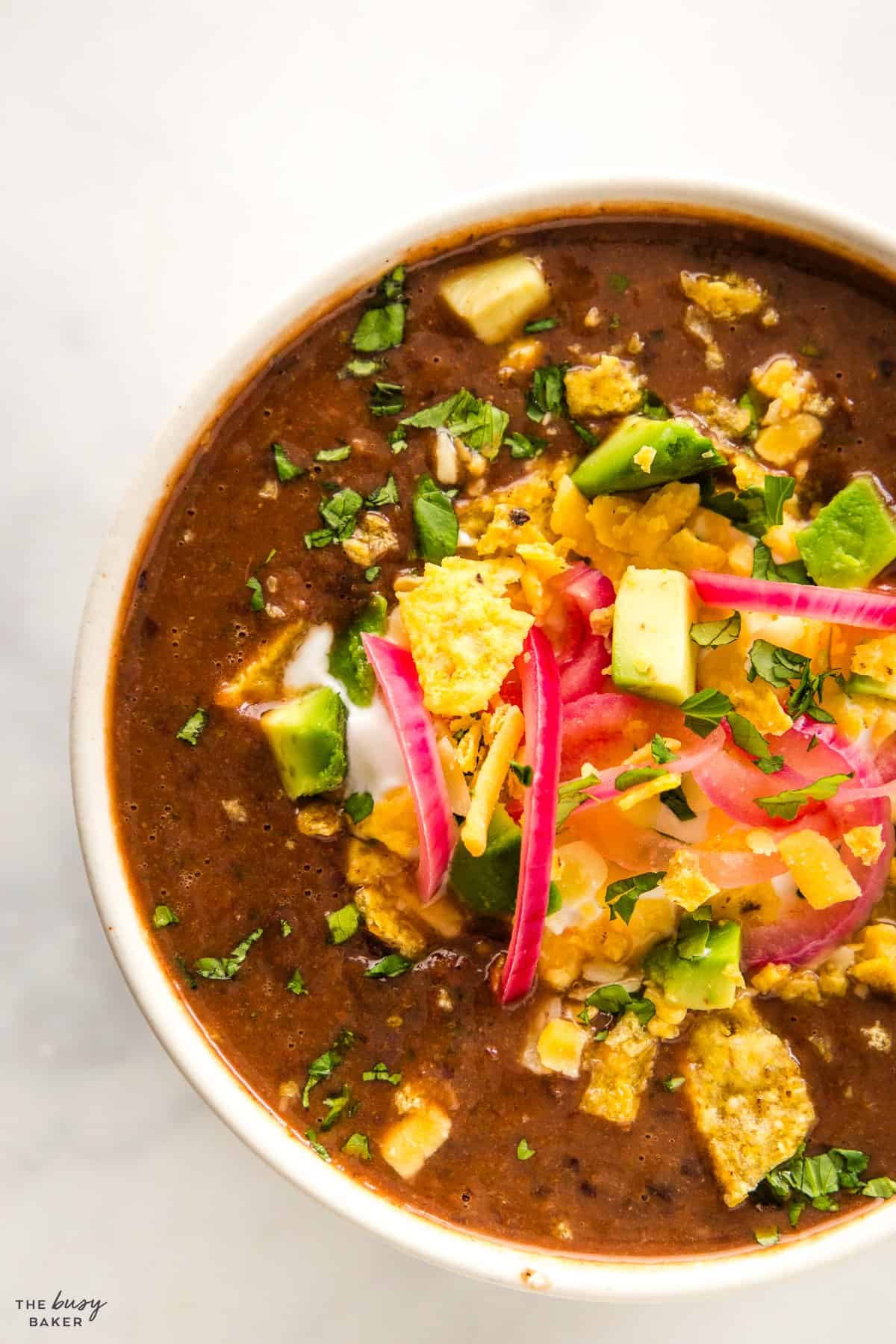 overhead image: black bean soup with crushed tortilla chips