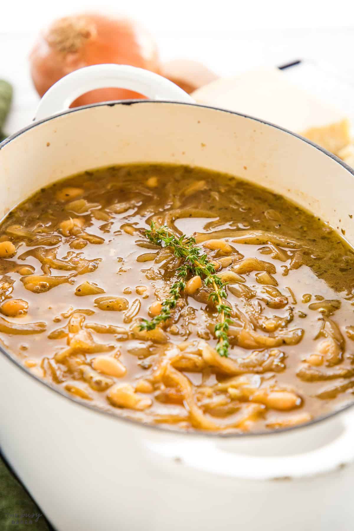 french onion soup in a pot with fresh thyme