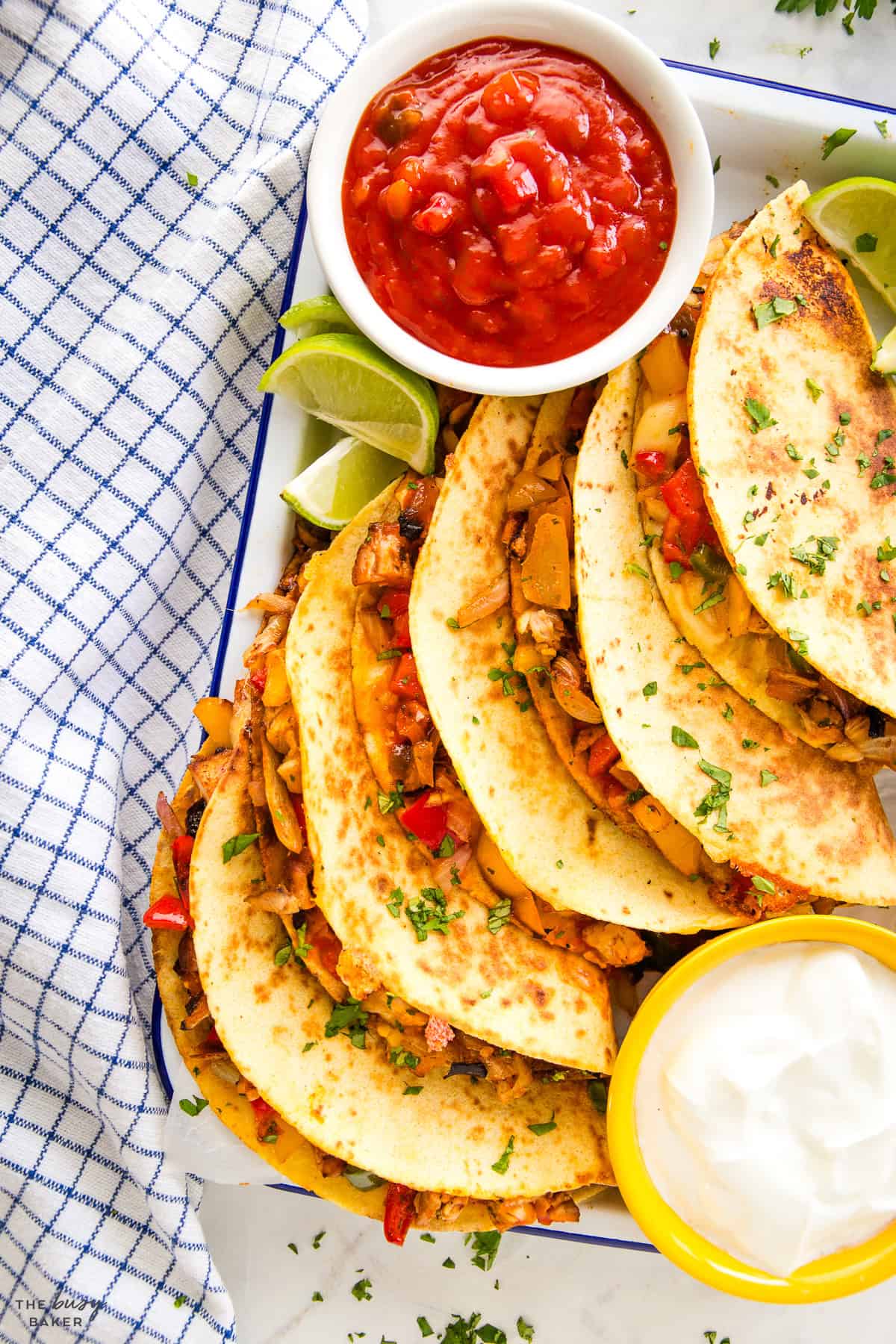 platter of quesadillas with salsa and sour cream