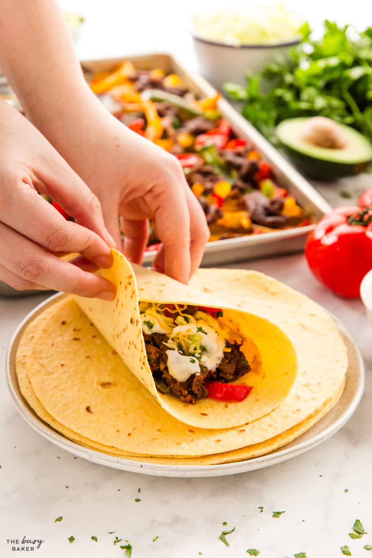 hands holding a steak fajita