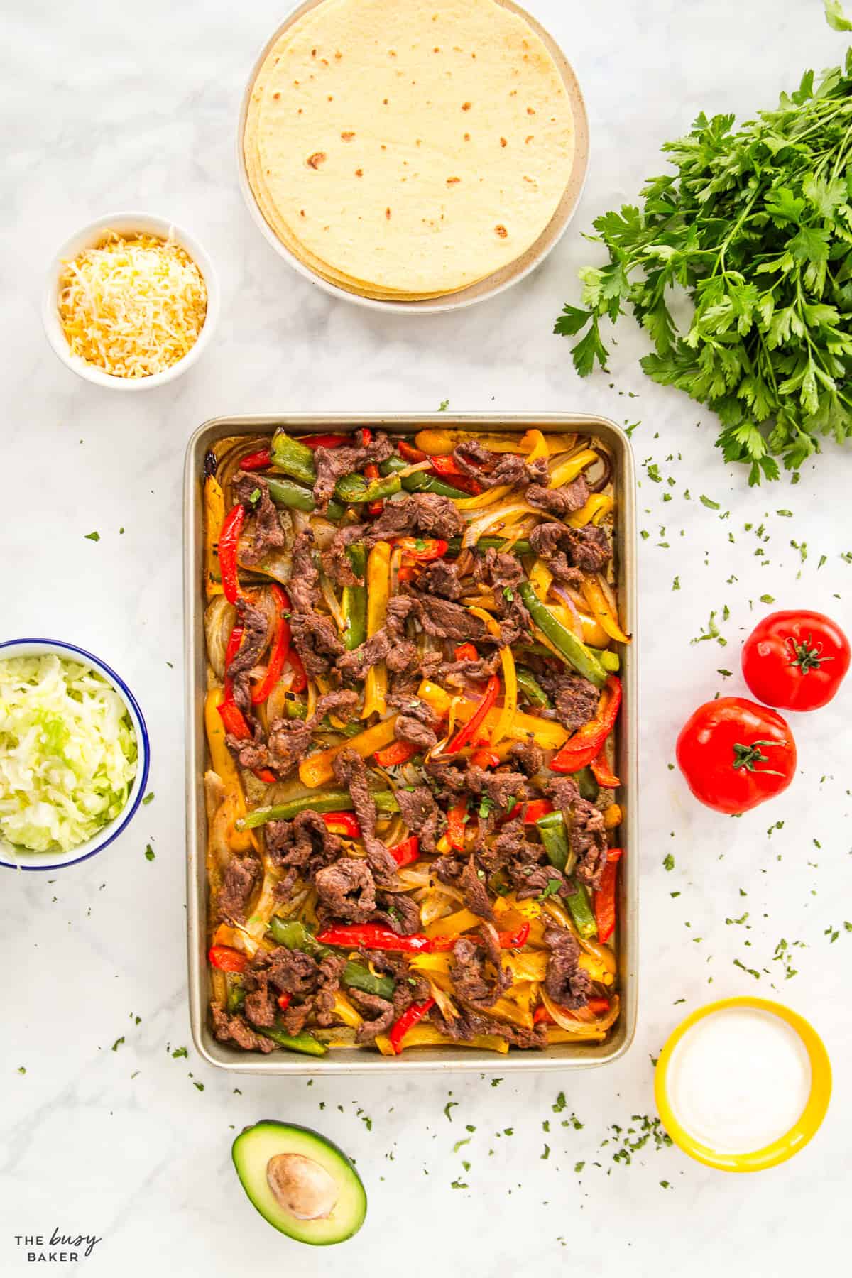 sheet pan steak fajitas recipe with fixings