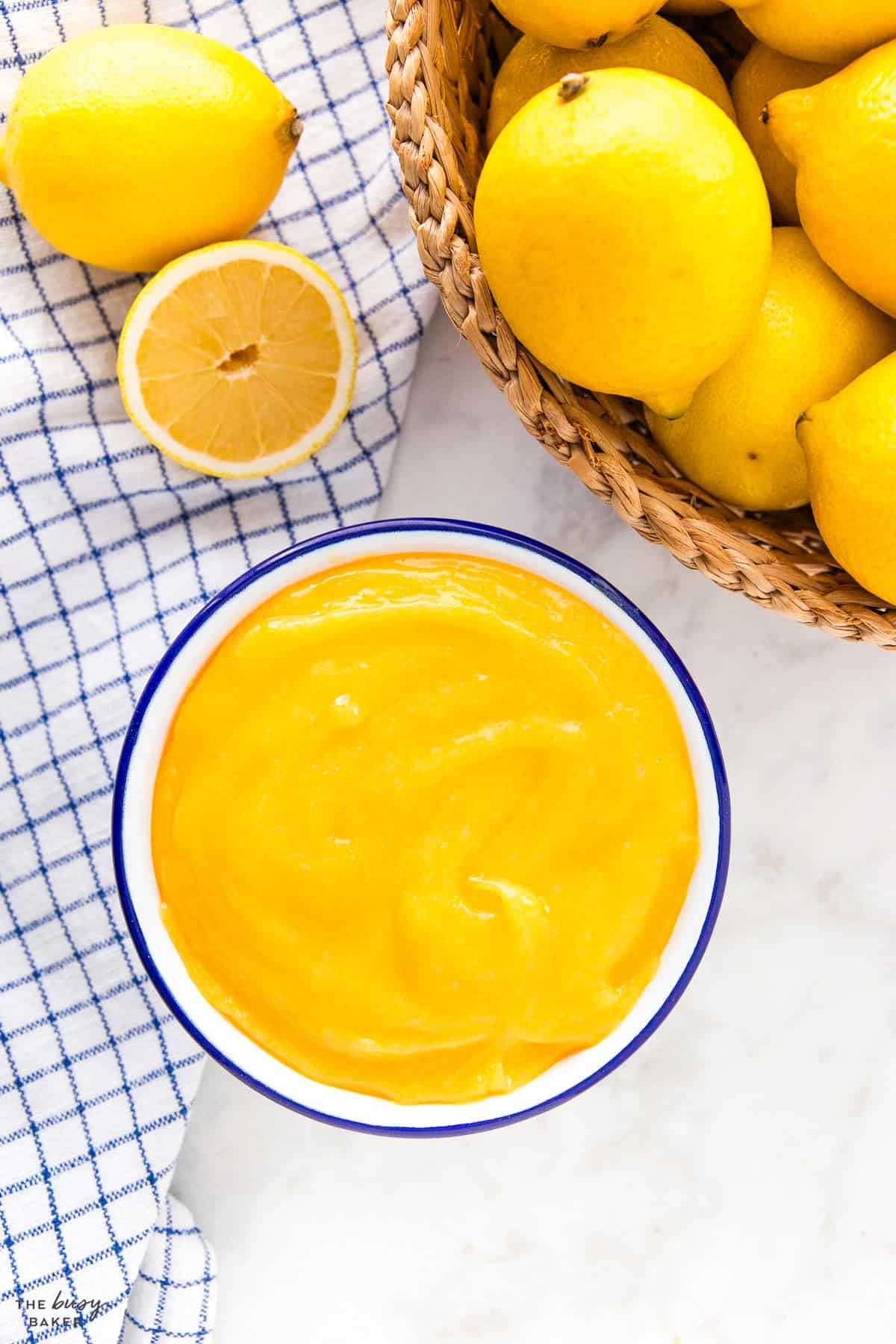 overhead image: lemon curd in a bowl with fresh lemons