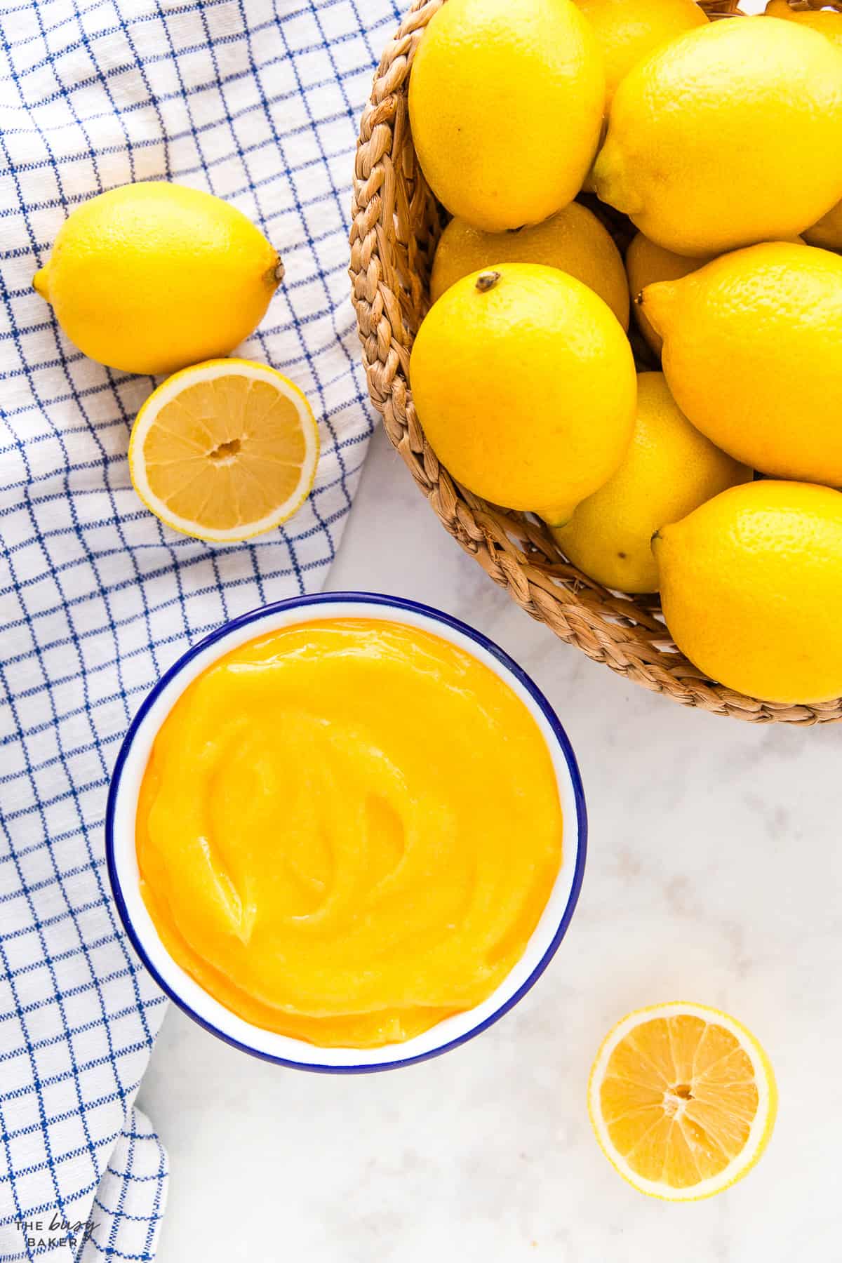 homemade lemon curd in a bowl with fresh lemons