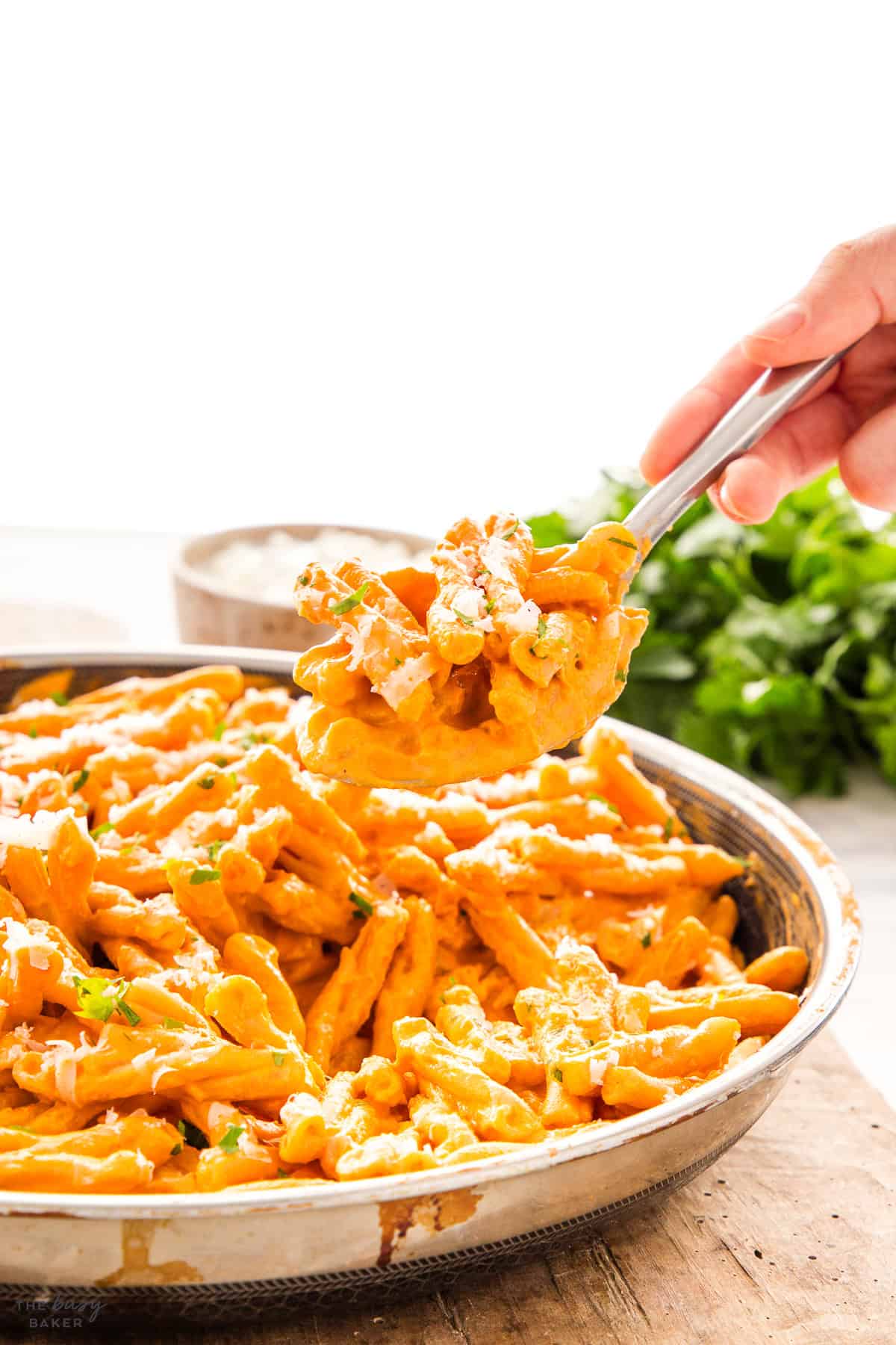 hand serving penne alla vodka