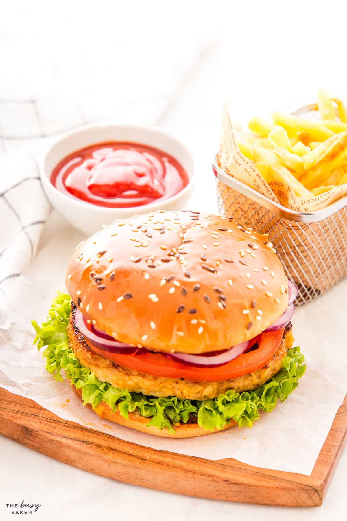 chicken burger with fries on a brioche bun