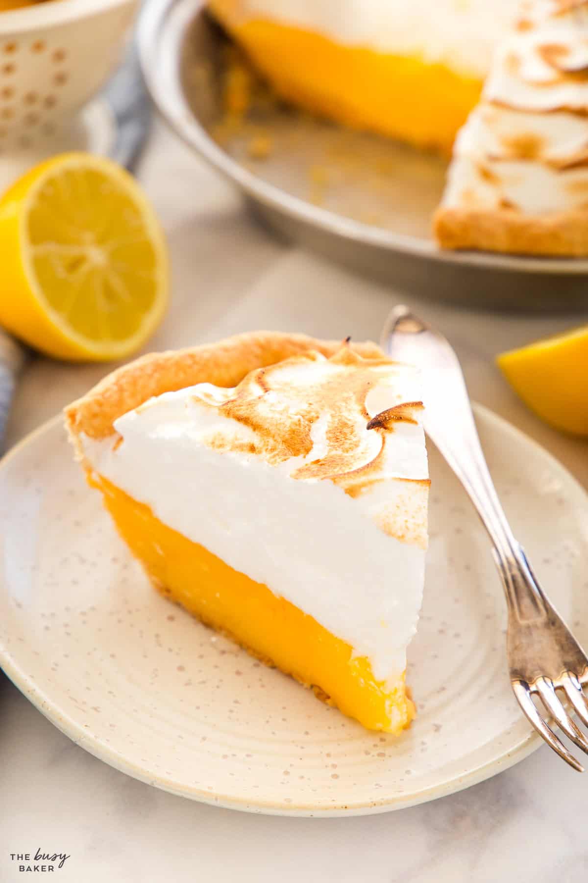 slice of lemon meringue pie on a plate with a fork