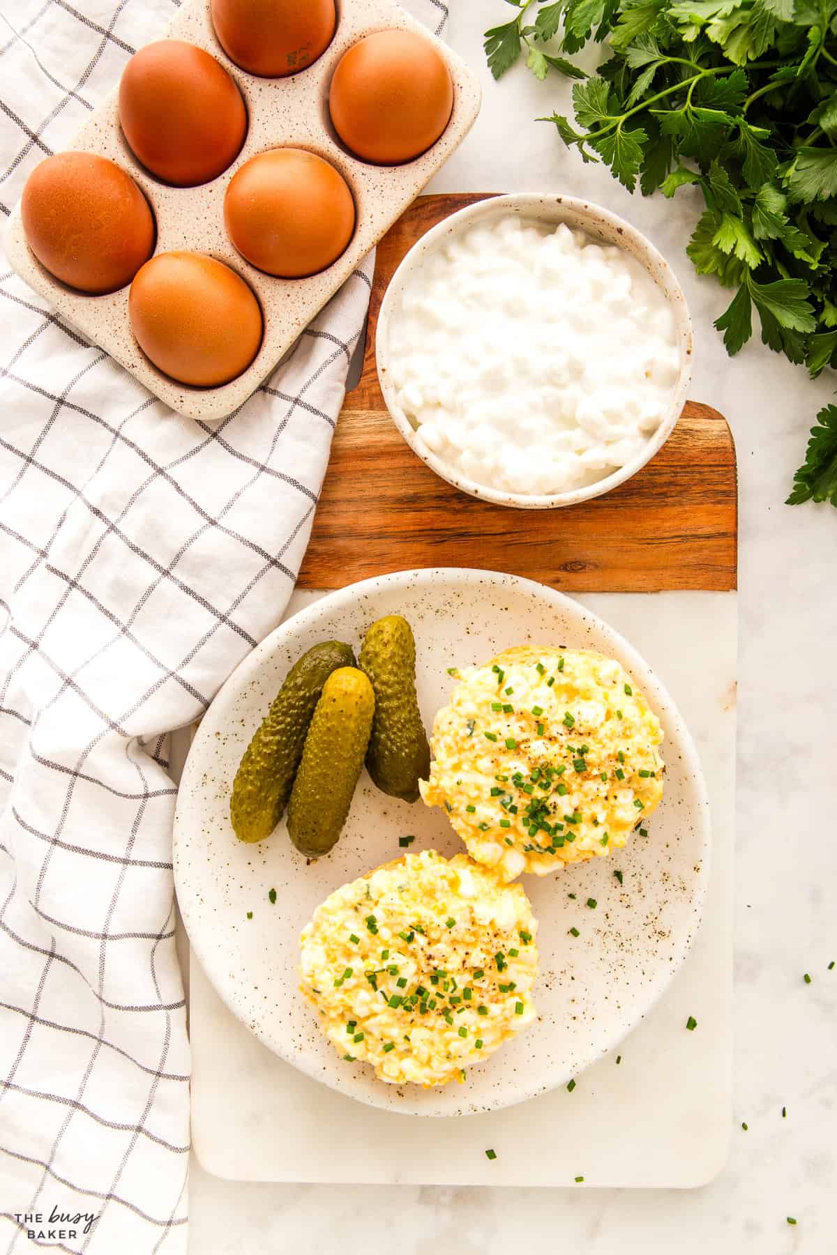 overhead image: protein egg salad on bagel with pickles