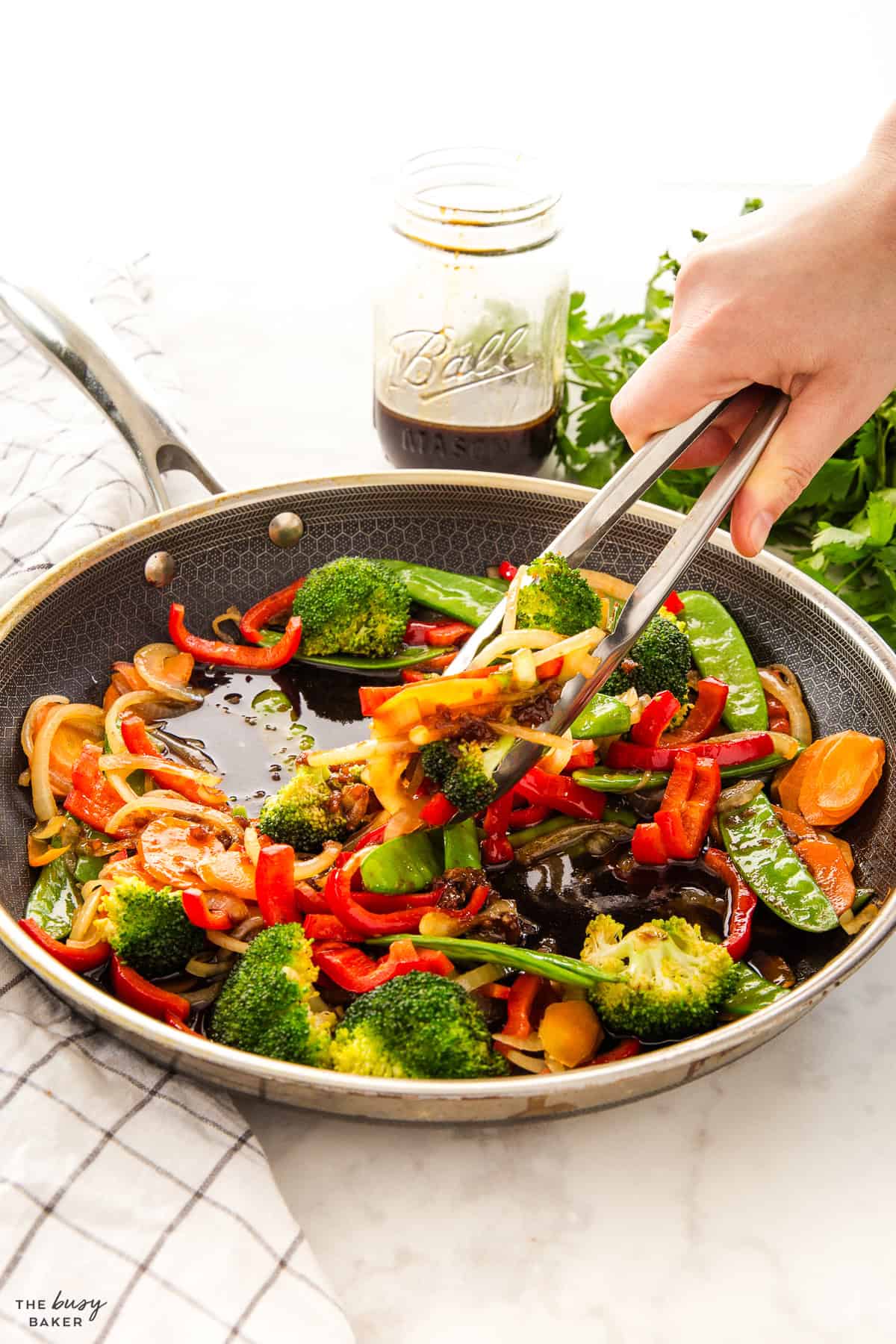 sauteed veggies in a skillet with sauce