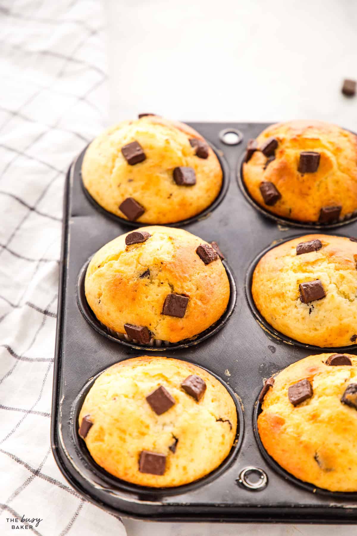 muffin tin with chocolate chunk muffins made with yogurt