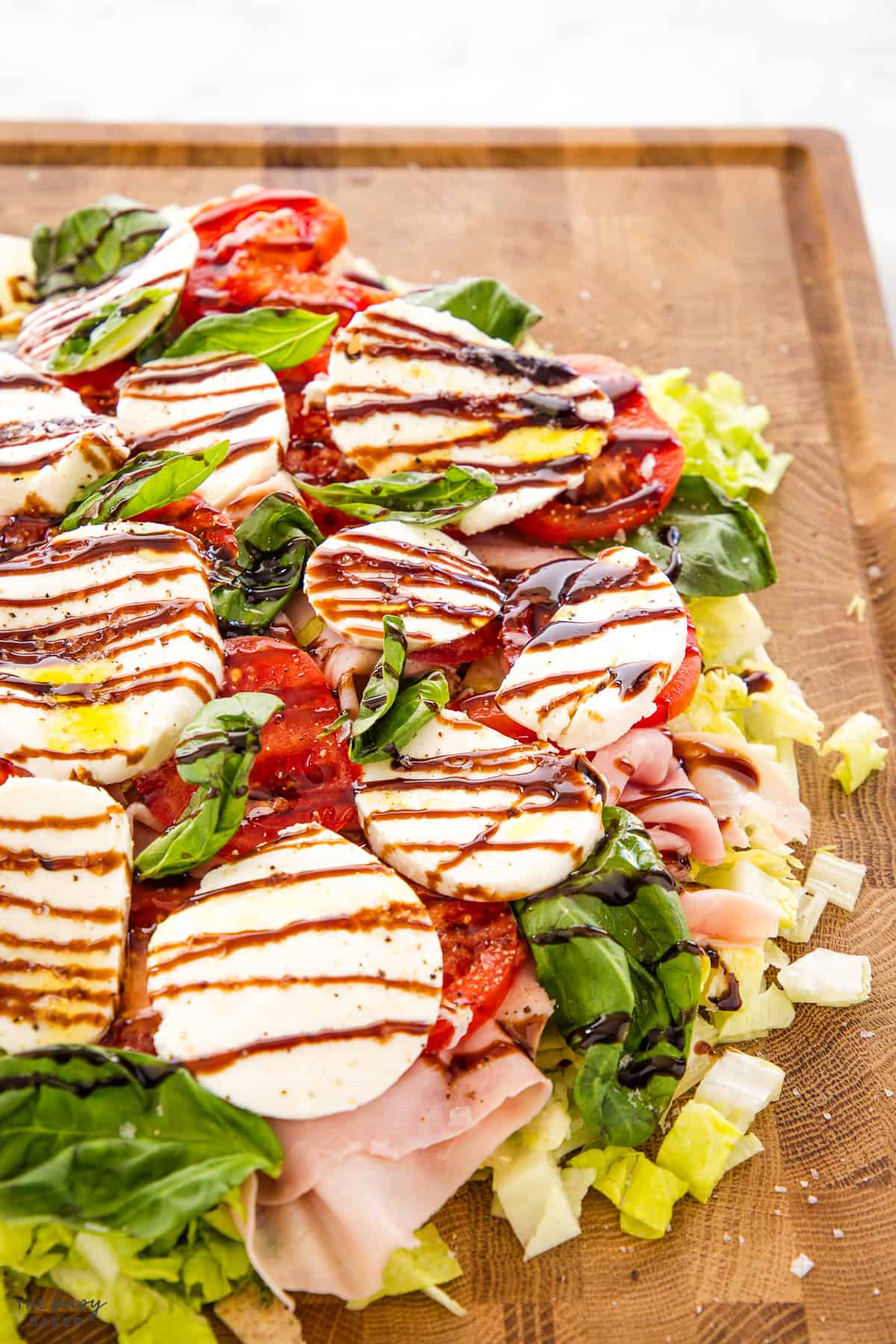 Italian style salad on a board with fresh mozzarella