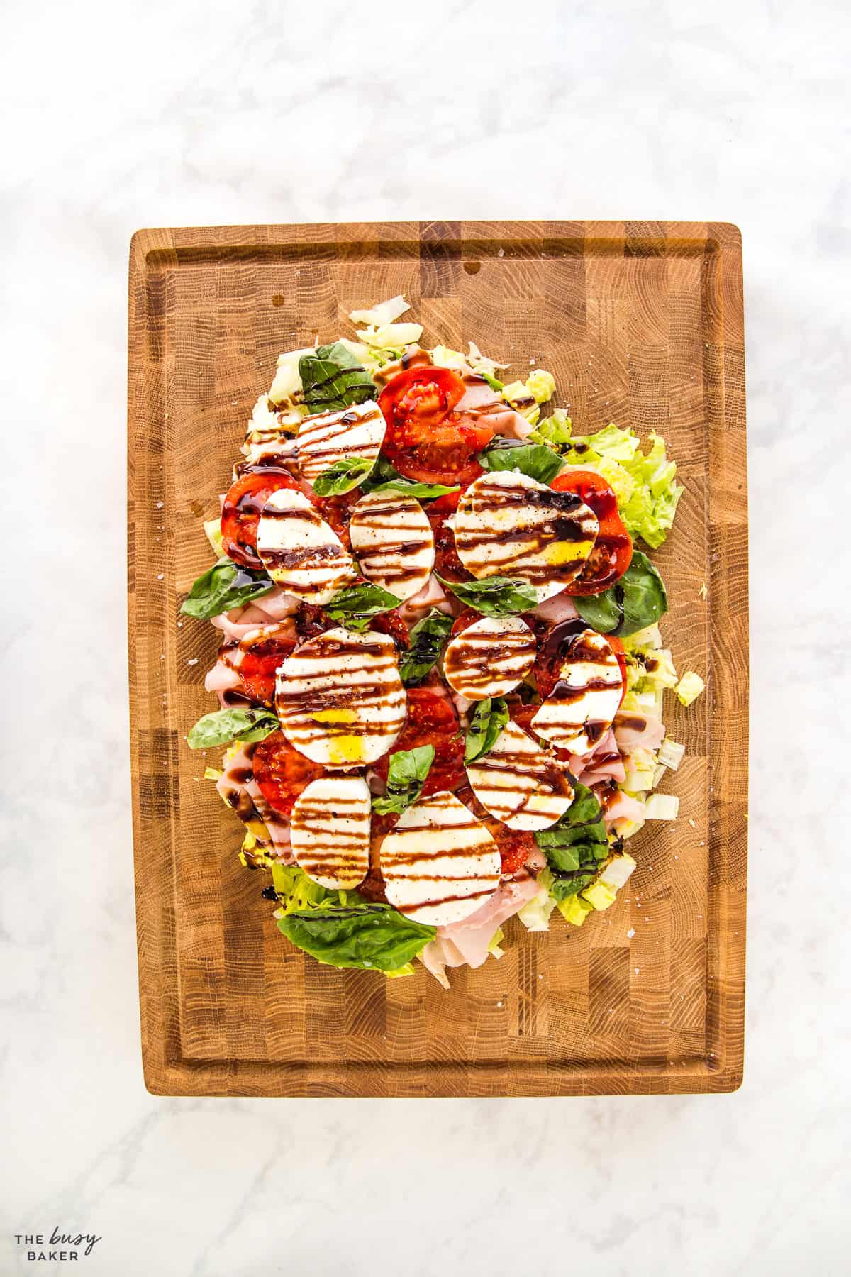 Italian style salad on a large wooden board