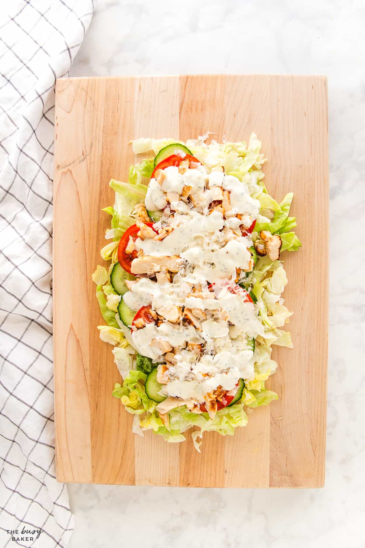 chicken caesar chopped salad on a board