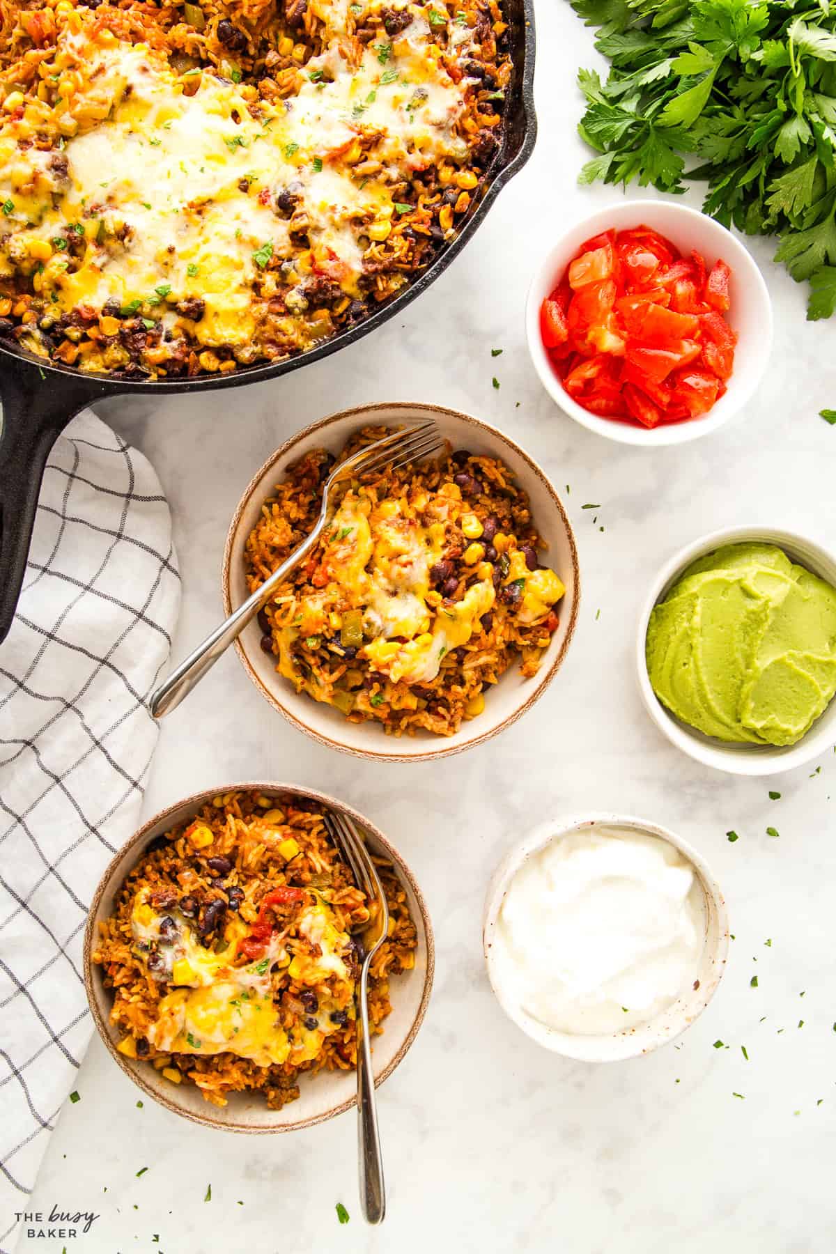 overhead image: mexican taco rice casserole in skillet and bowls