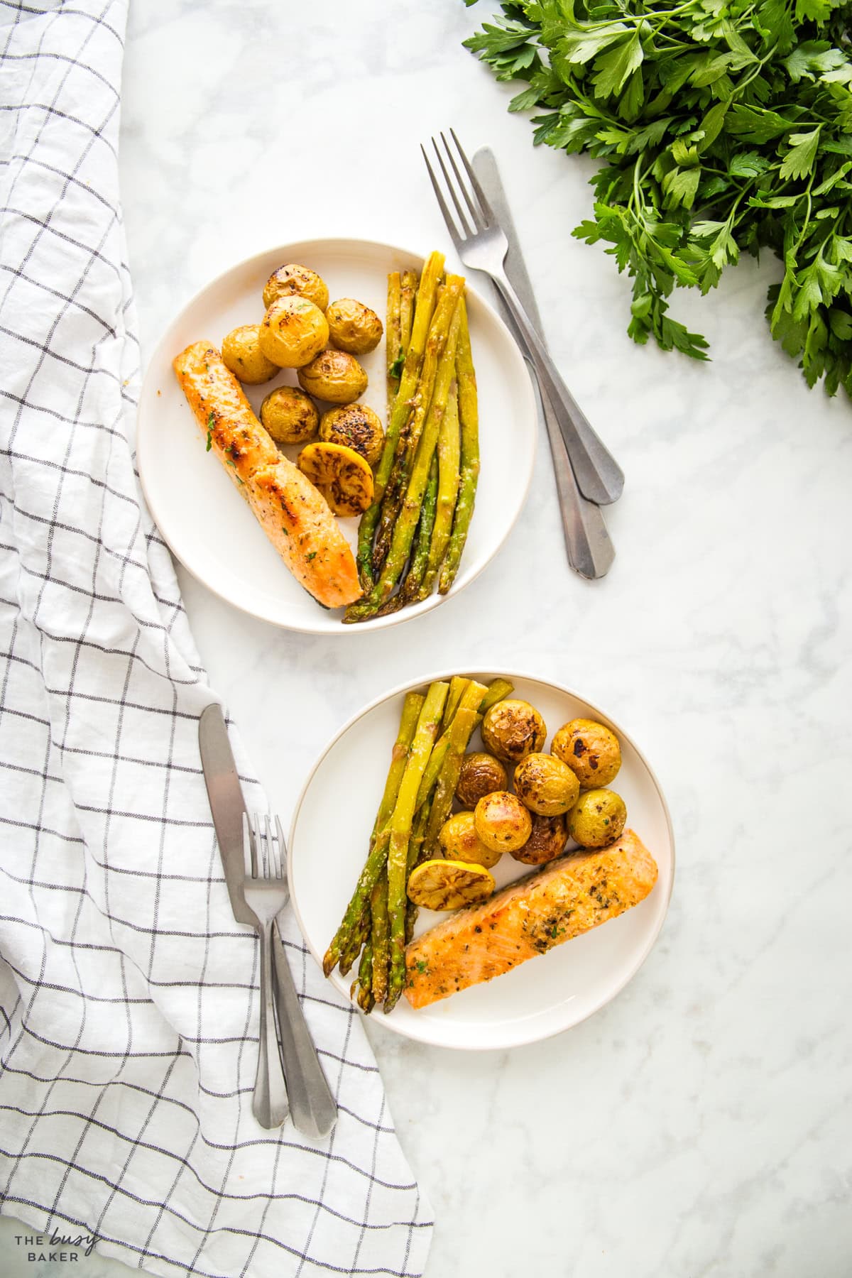 overhead image: salmon and veggies on white plates