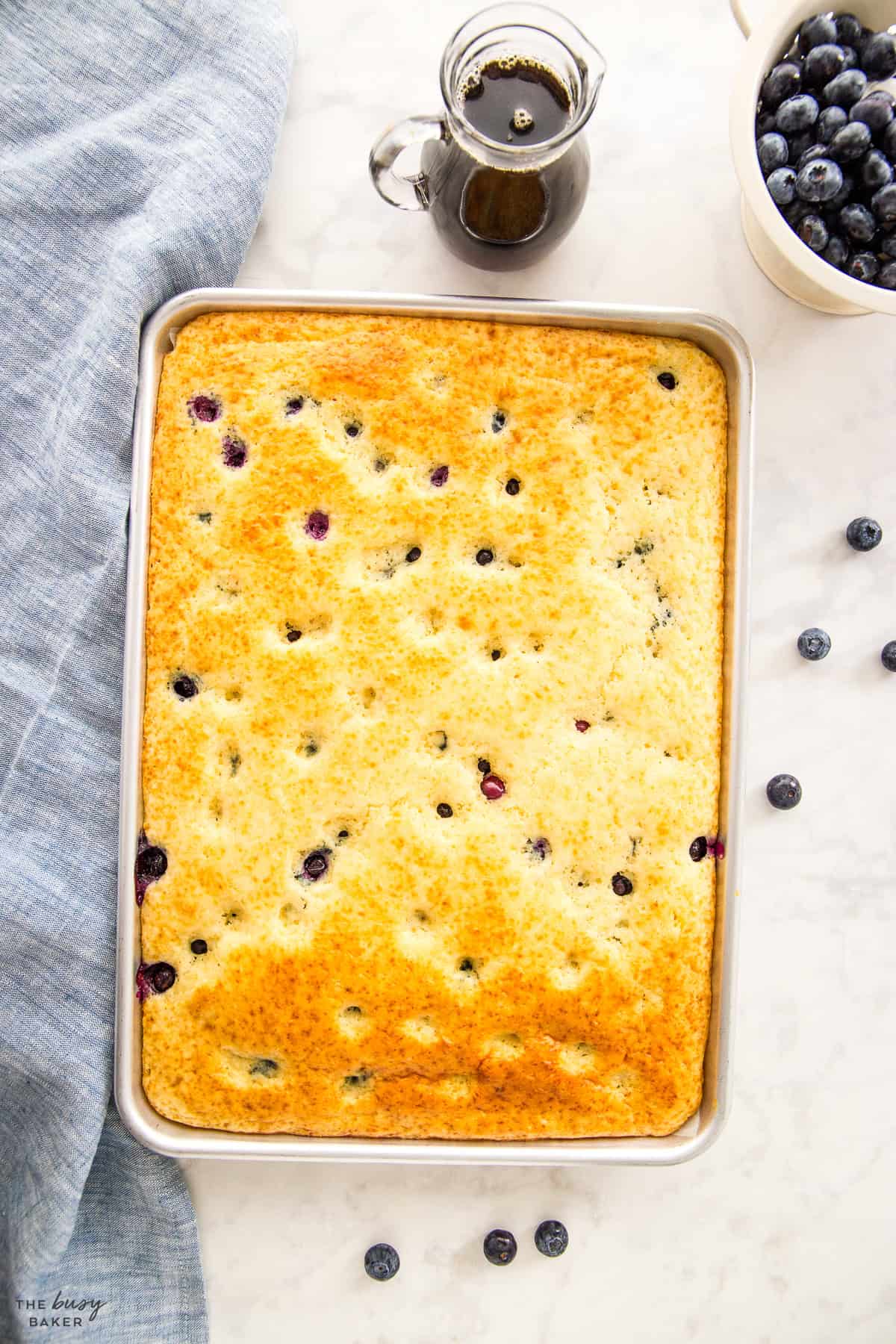 sheet pan pancakes on a baking pan with blueberries