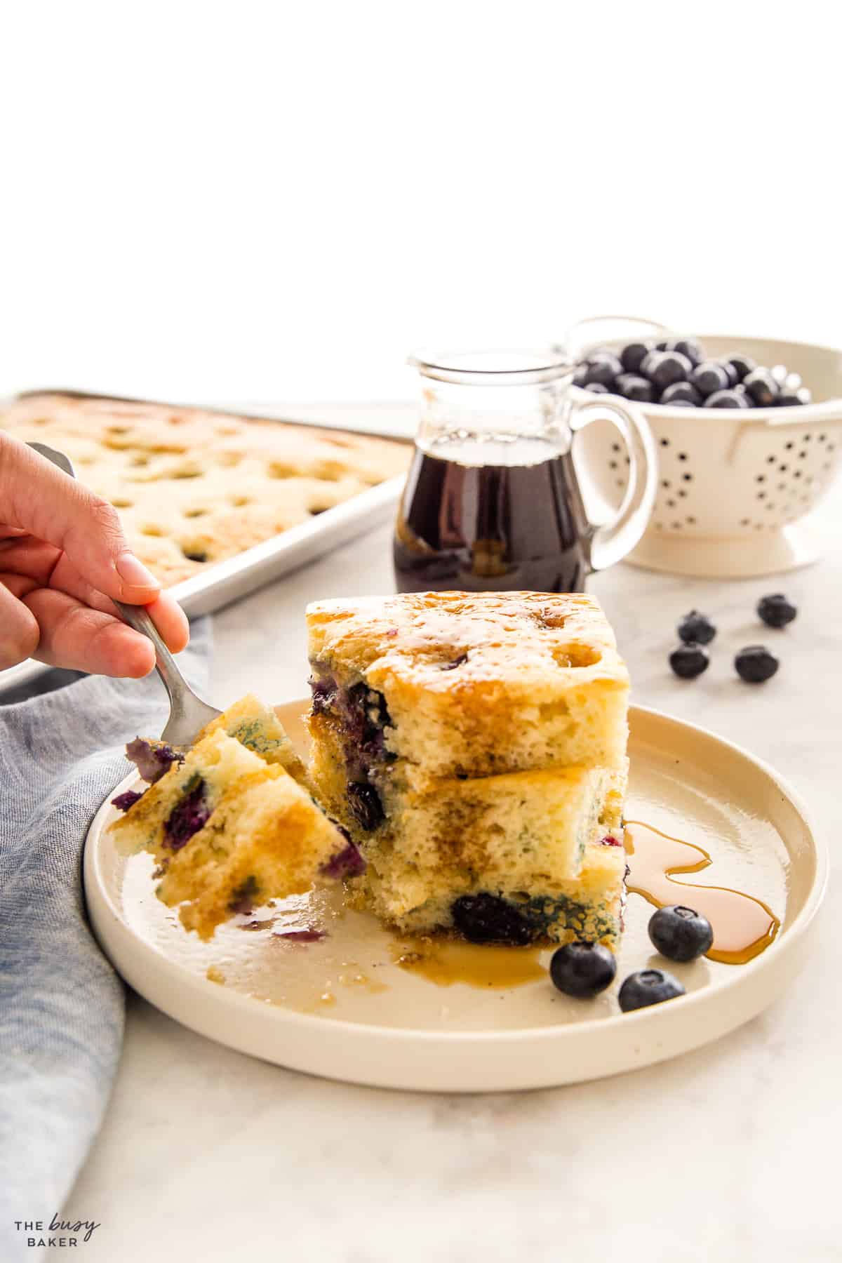 a stack of sheet pan pancakes with blueberries