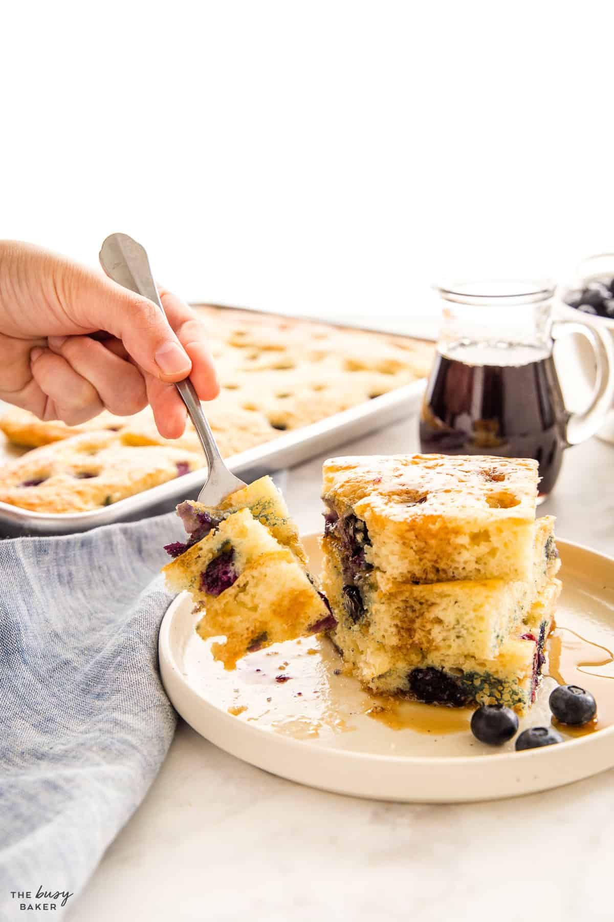 hand holding a fork full of sheet pan pancakes