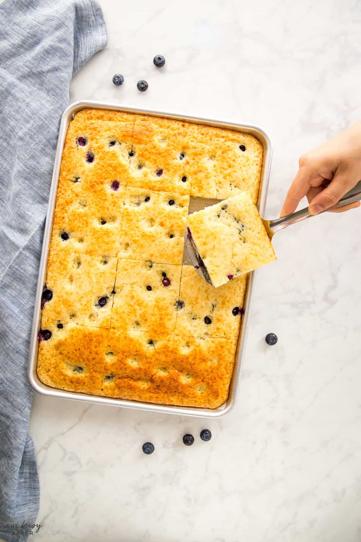 hand serving sheet pan pancakes