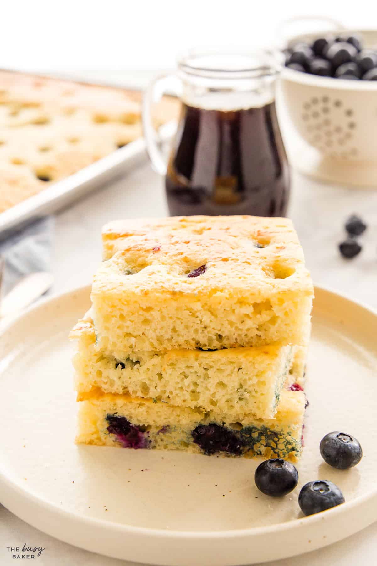 fluffy sheet pan pancakes on a plate with blueberries